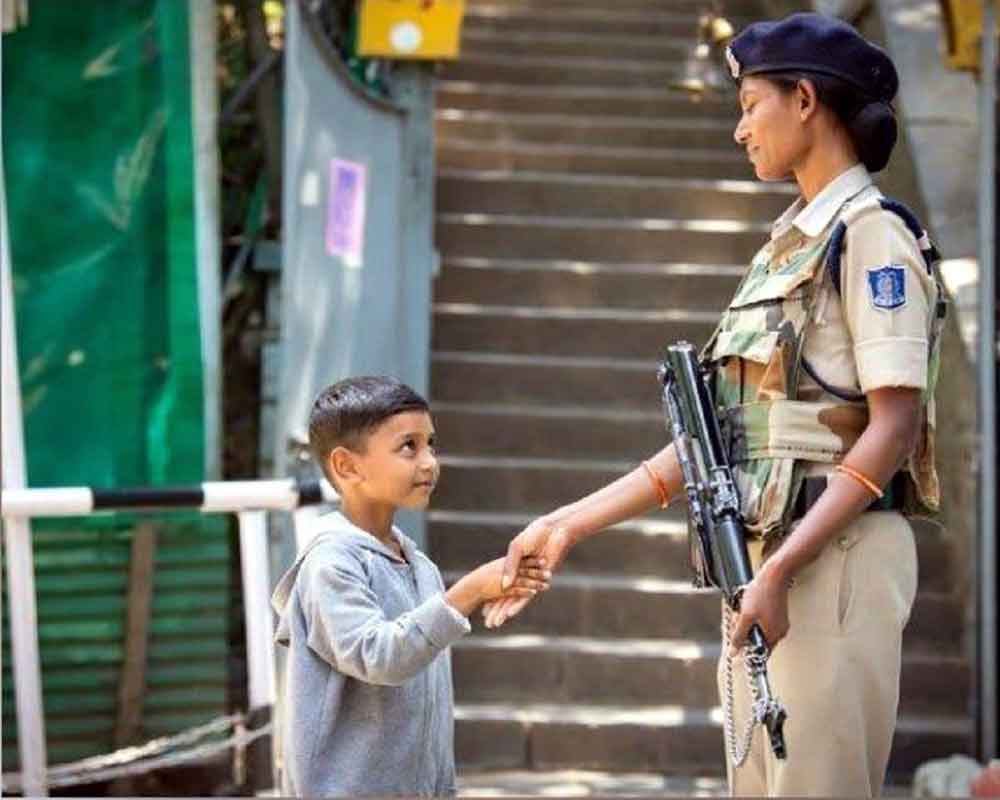 Adorable photo of Kashmiri child shaking hands with CRPF personnel wins hearts