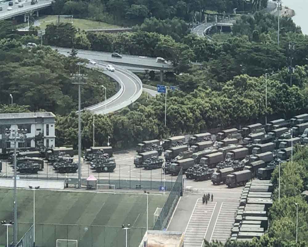 Chinese military personnel parade near Hong Kong border