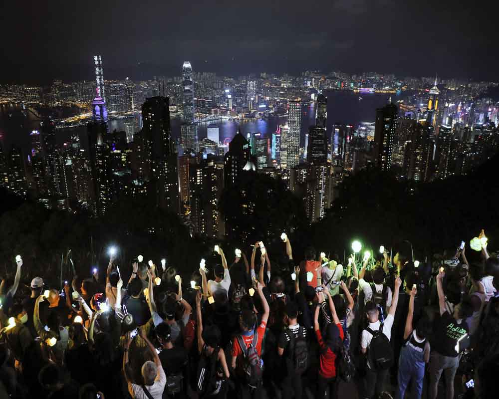 Hong Kong hills shine with protest lights in festival-themed rally