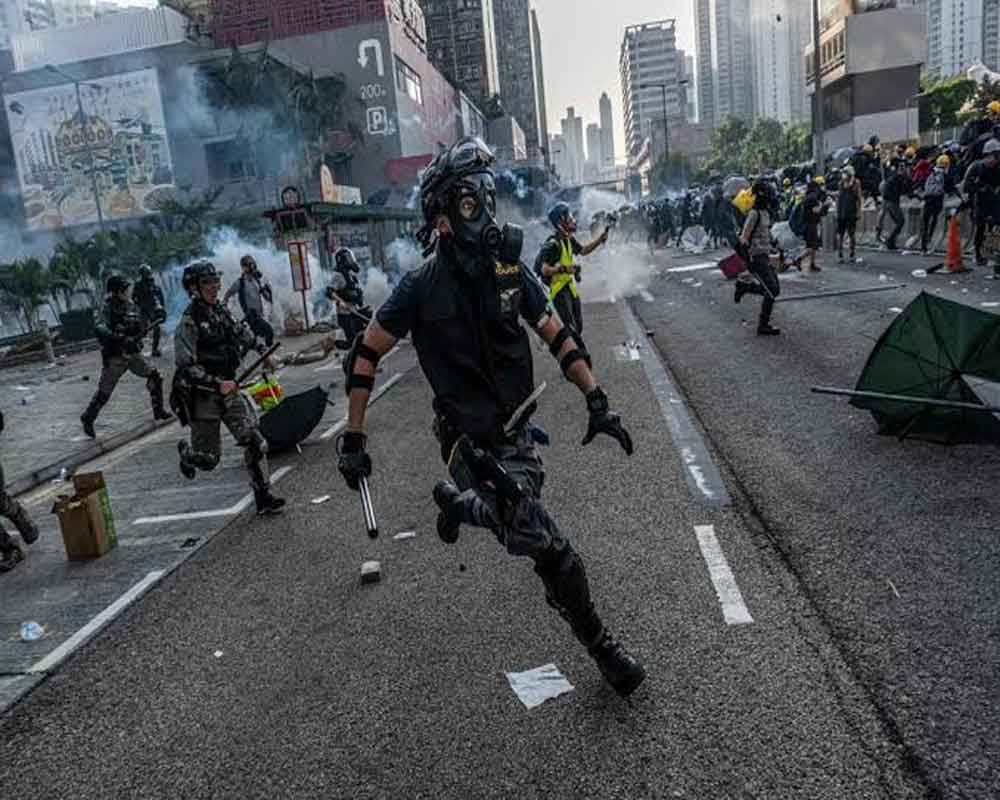 Hong Kong police shoot protester as flashmob rallies target rush hour