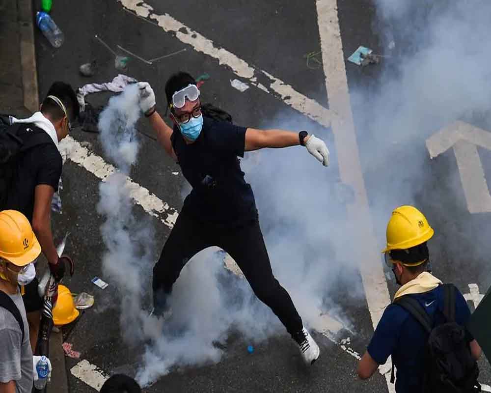 Thousands march as Hong Kong government mulls face mask ban