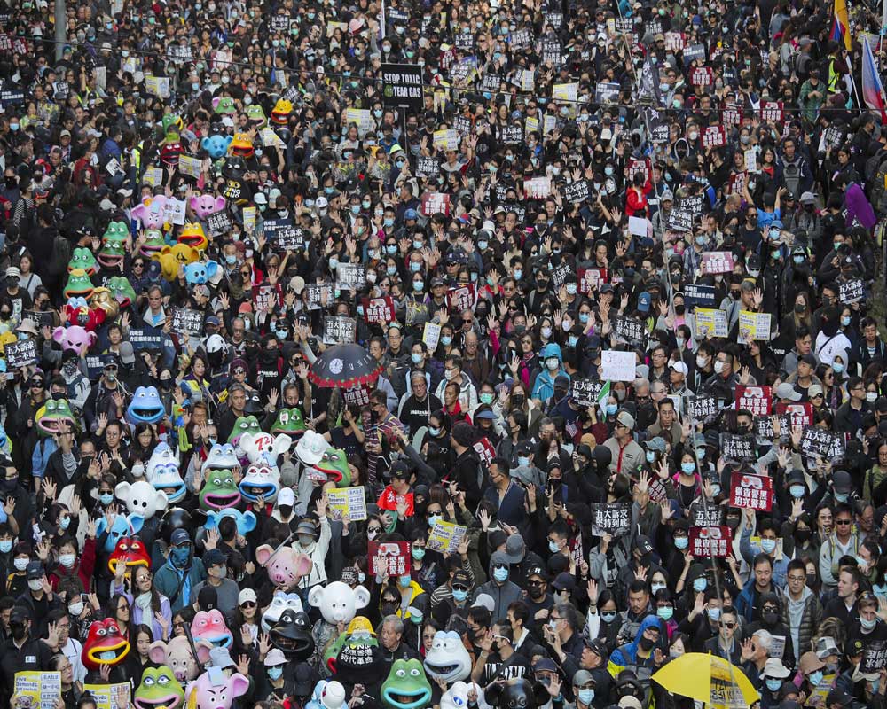 Hong Kongers mark half year protest anniversary with huge rally