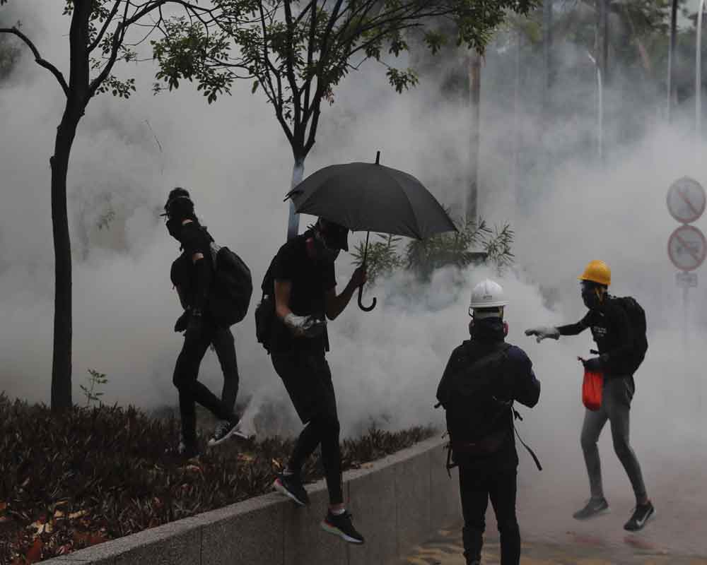 Police fire tear gas as large crowds defy Hong Kong mask ban
