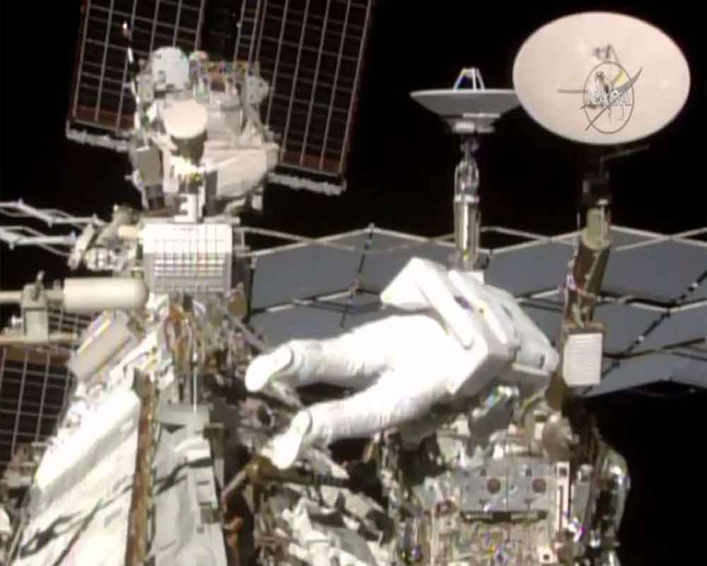 Spacewalking astronauts add parking spot to space station