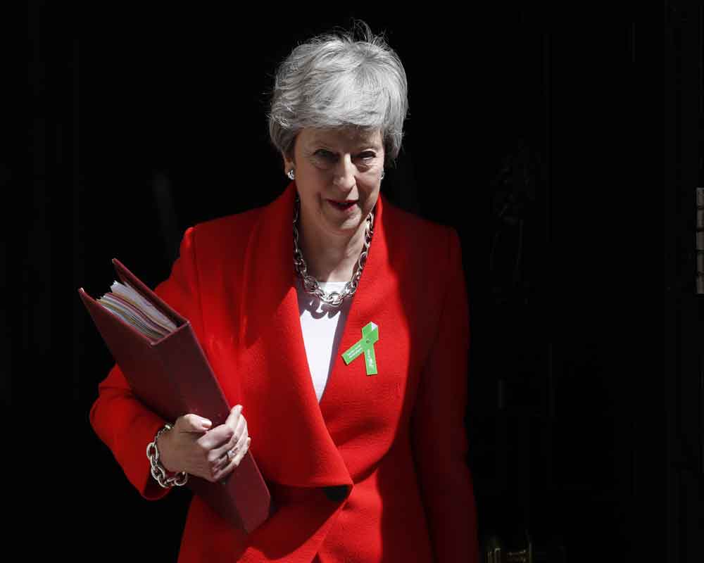 UK PM May promises timetable in June for her exit date