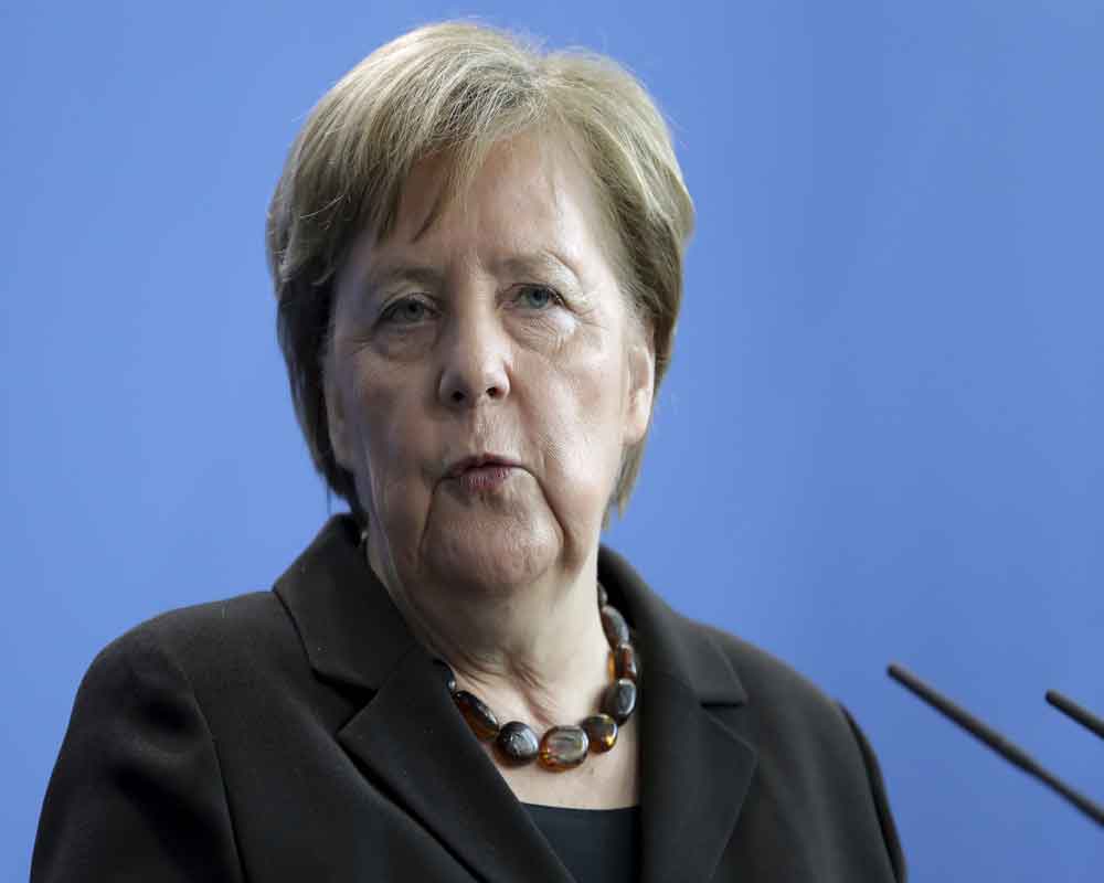 Merkel slams 'poison' of racism after nine killed in Germany shootings