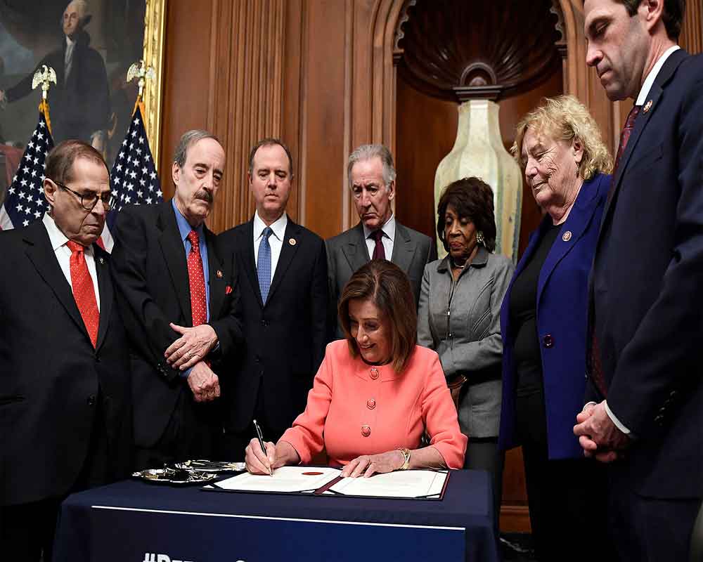 Pelosi signs articles of impeachment against Trump, House delivers them to Senate
