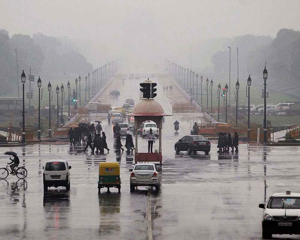 Delhi sees light rain, gusty winds bring down mercury