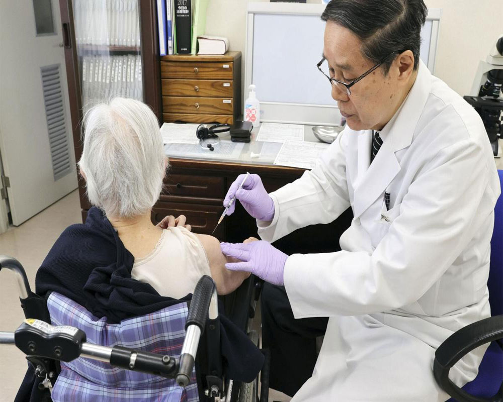 Tokyo adopts tougher virus rules, starts vaccinating elders