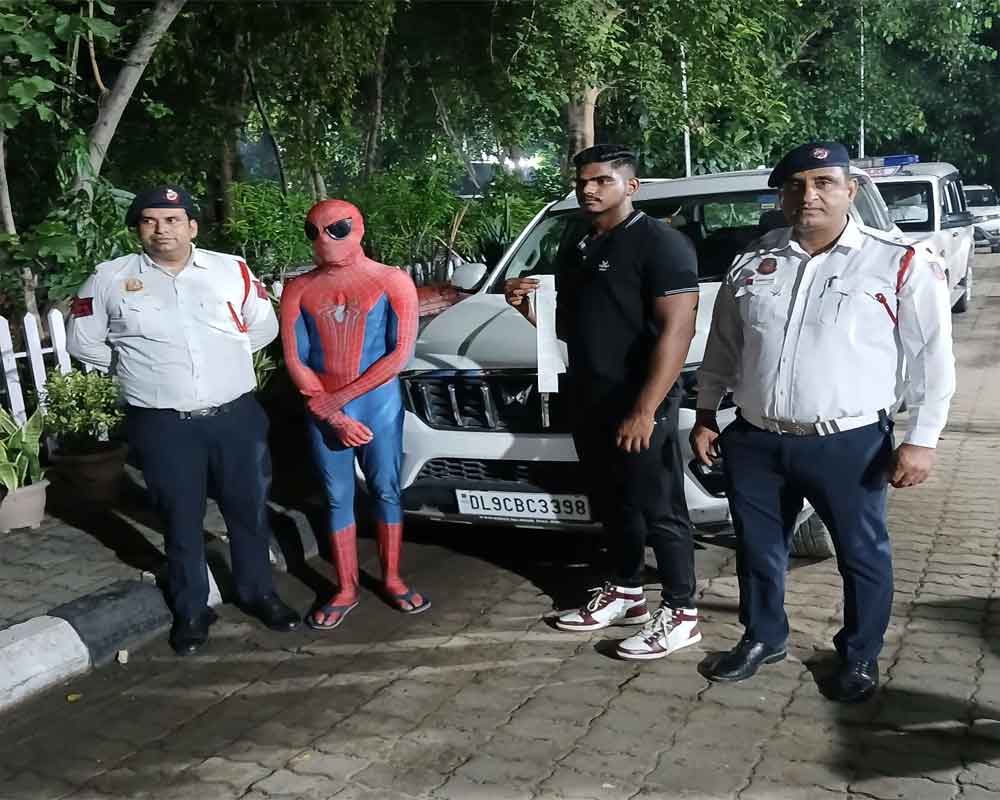 'Spiderman' rides on car's bonnet in Delhi, booked for traffic violations