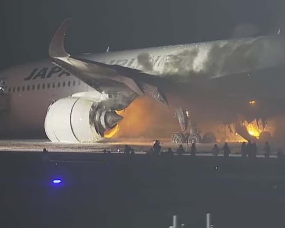 Plane catches fire on runway at Japan's Haneda airport, passengers reportedly safe
