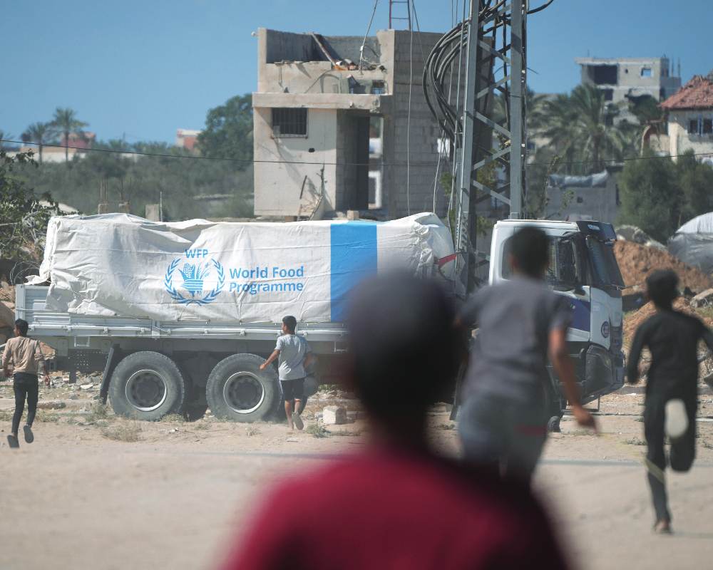 Israel to halve aid into Gaza over slow return of dead hostages