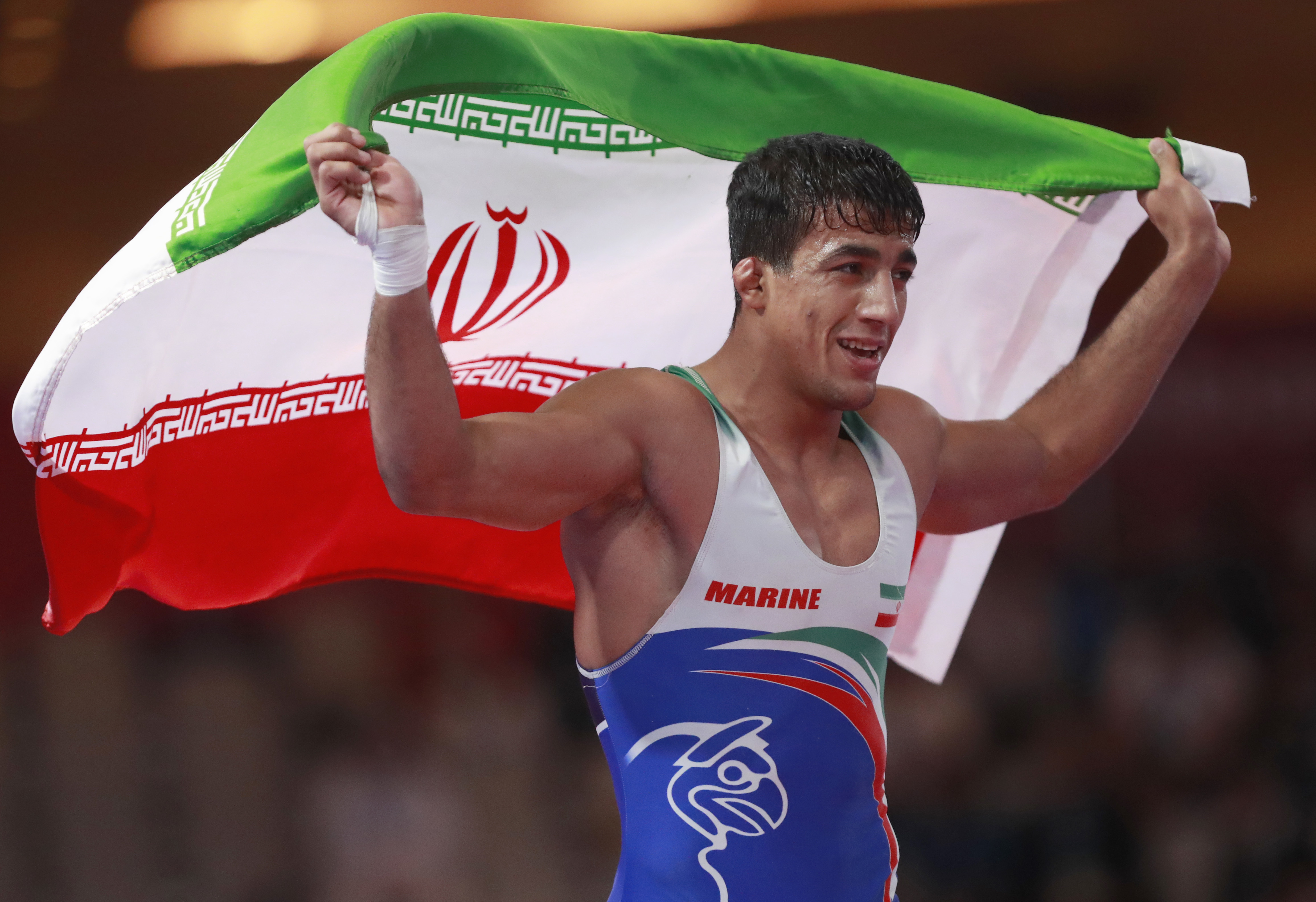 Iran`s Mohamadali Geraei celebrates after