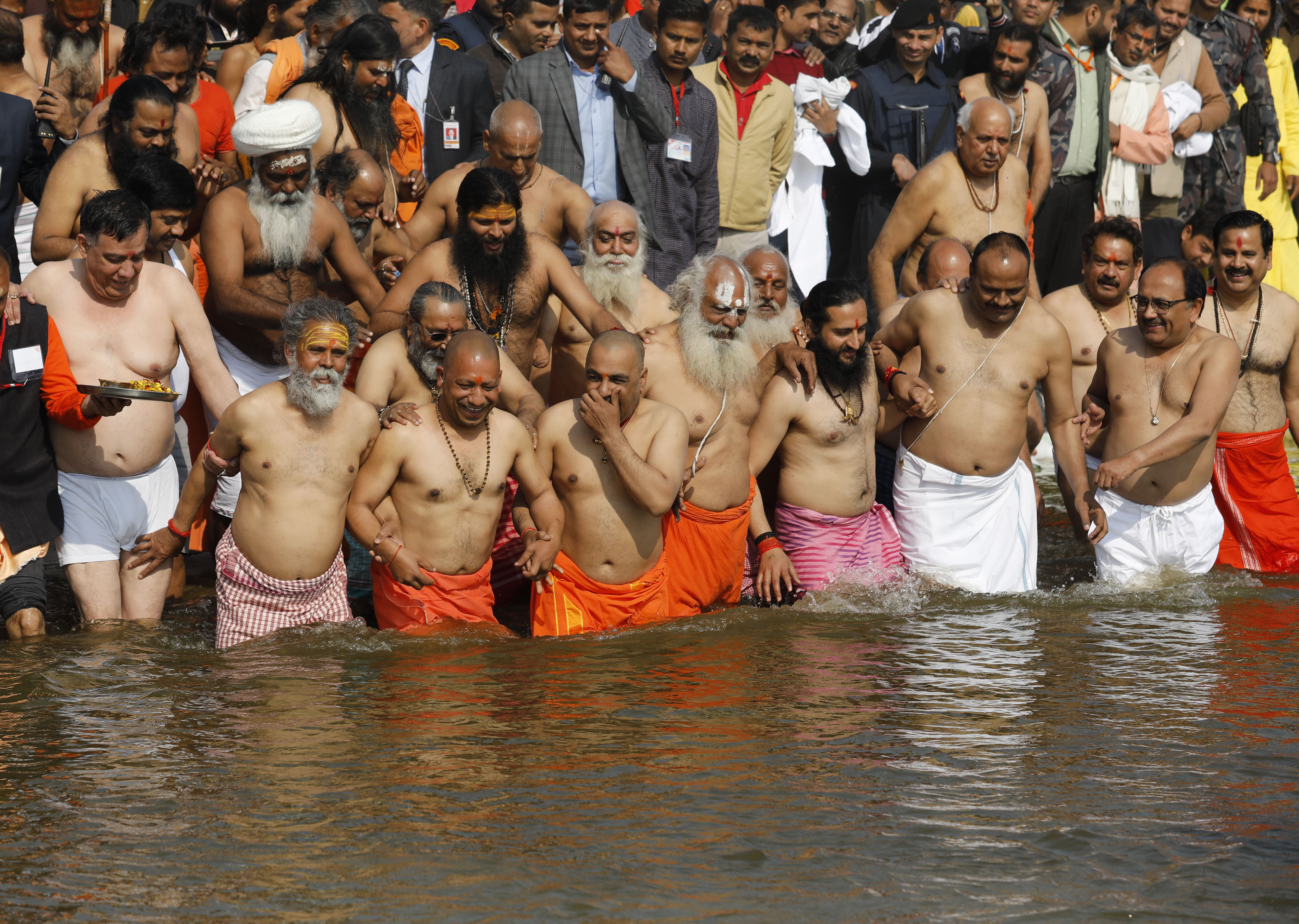 Chief Minister of Uttar Pradesh state Yogi Adityanath, front second left, takes a holy dip accompanied by saints and cabinet colleagues at the Sangam, the confluence of rivers Ganges and Yamuna, during the Kumbh Mela in Prayagraj - AP