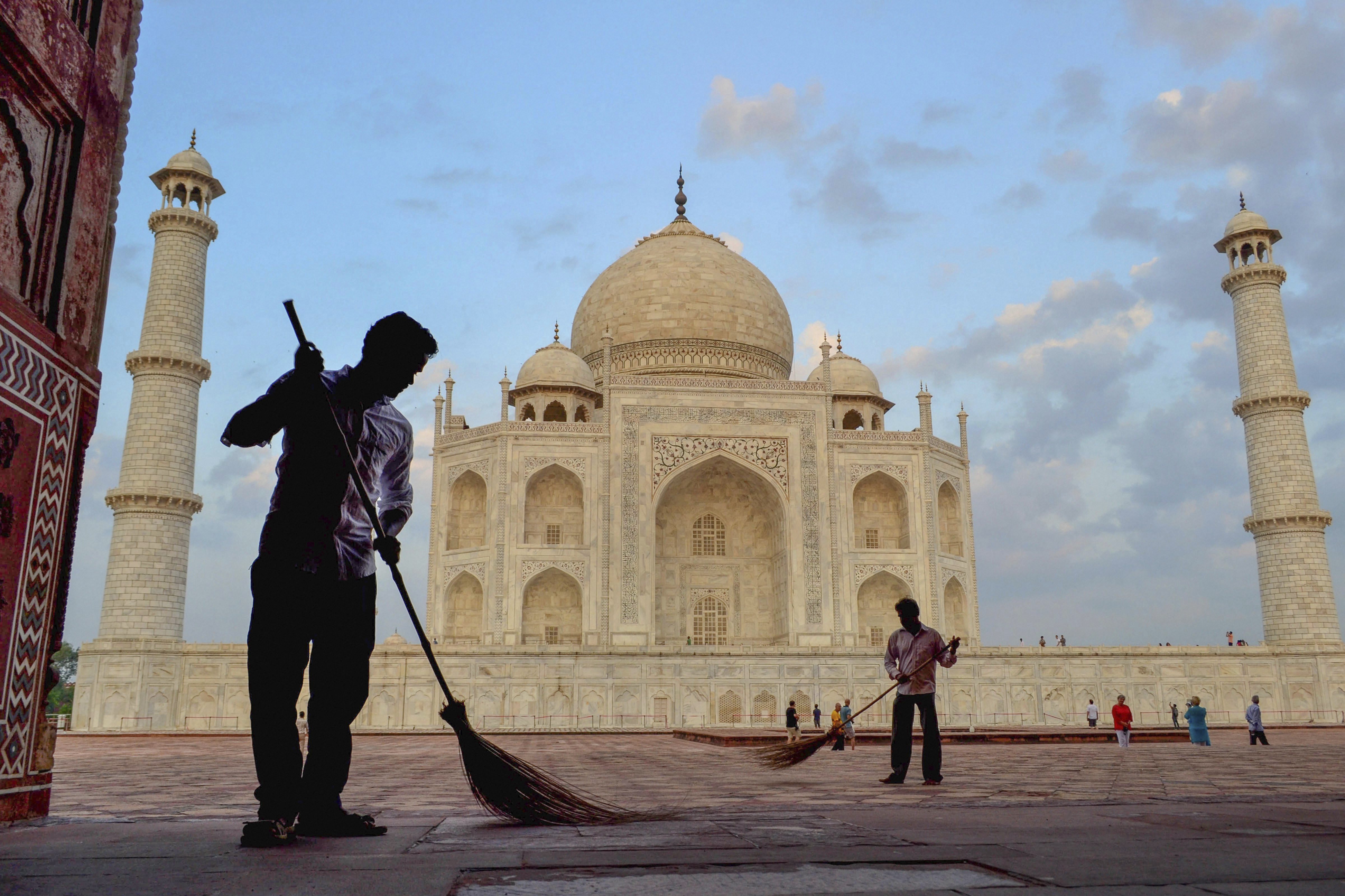 Workers sweep the premises of Taj Mahal under 'Swachhta hi Seva' campaign, in Agra - PTI