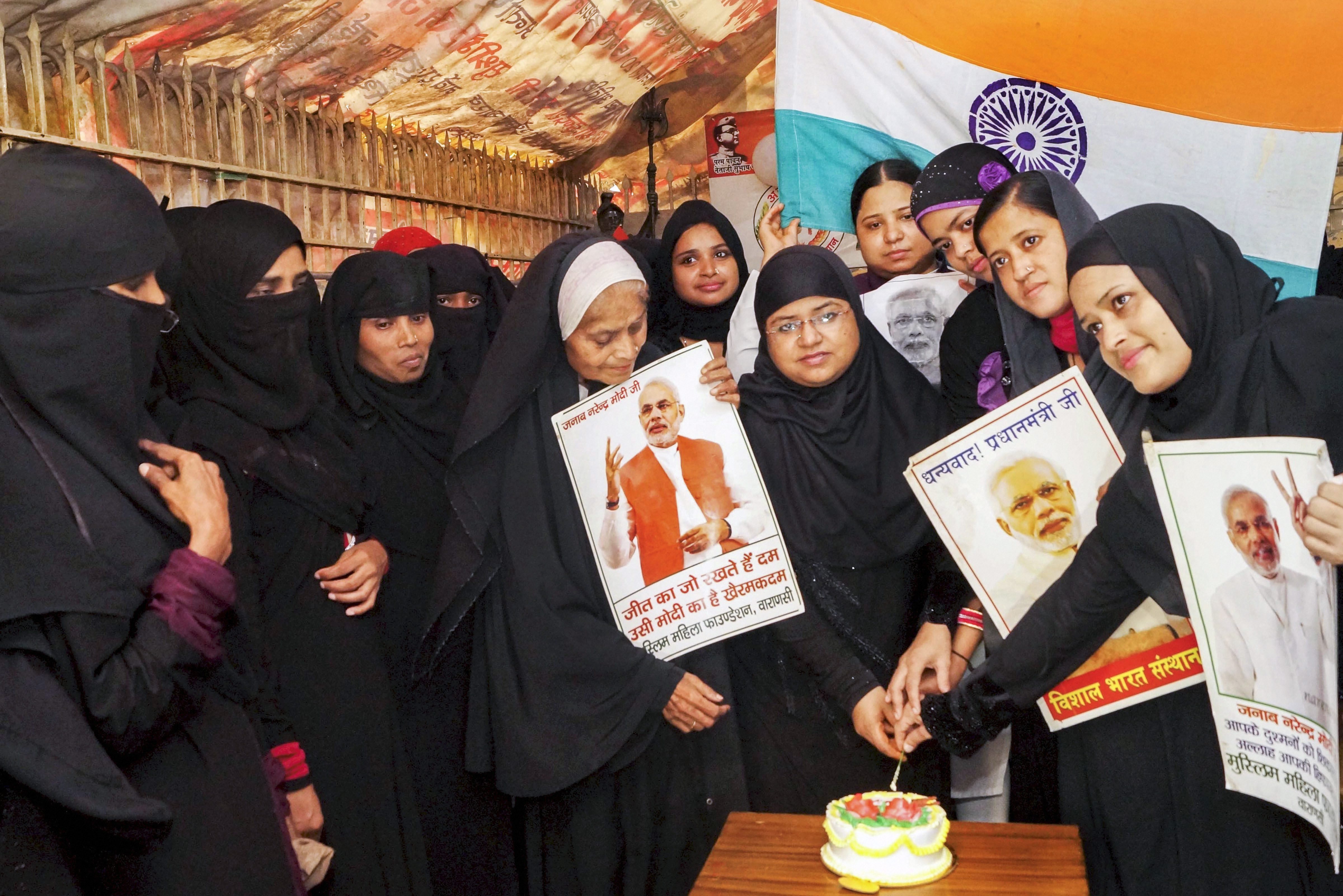 Muslim women cut a cake ahead of Prime Minister Narendra Modi's birthday, in Varanasi - PTI