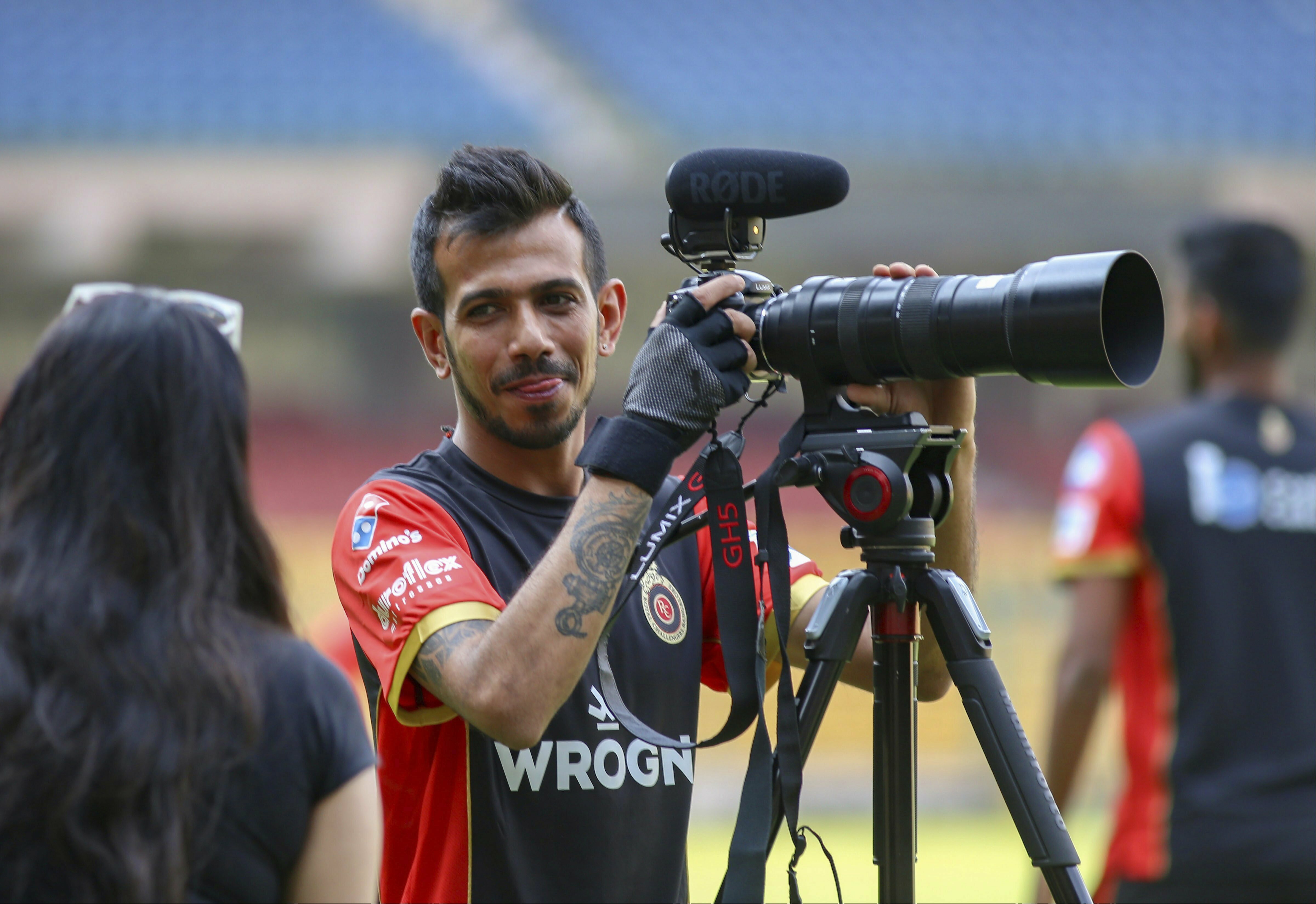 Royal Challengers Bangalore Yuzvendra Chahal operates a camera during a practice session ahead of IPL 2019 at Chinnaswamy Stadium in Bengaluru - PTI