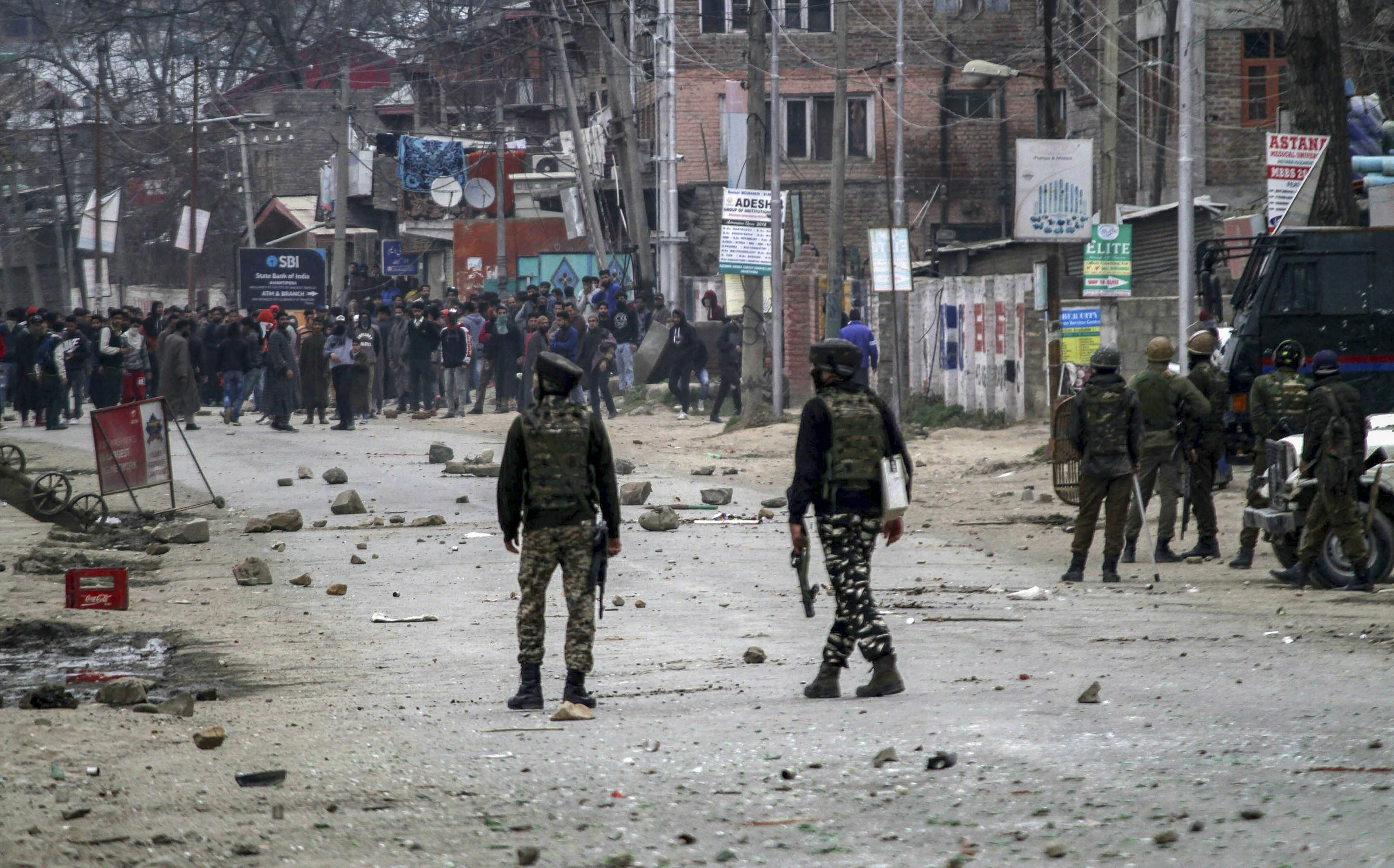 Youth hurls stones at security forces during a protest against the death of Rizwan Asad, who allegedly died in Police custody, in Awantipora area of Pulwama district - PTI