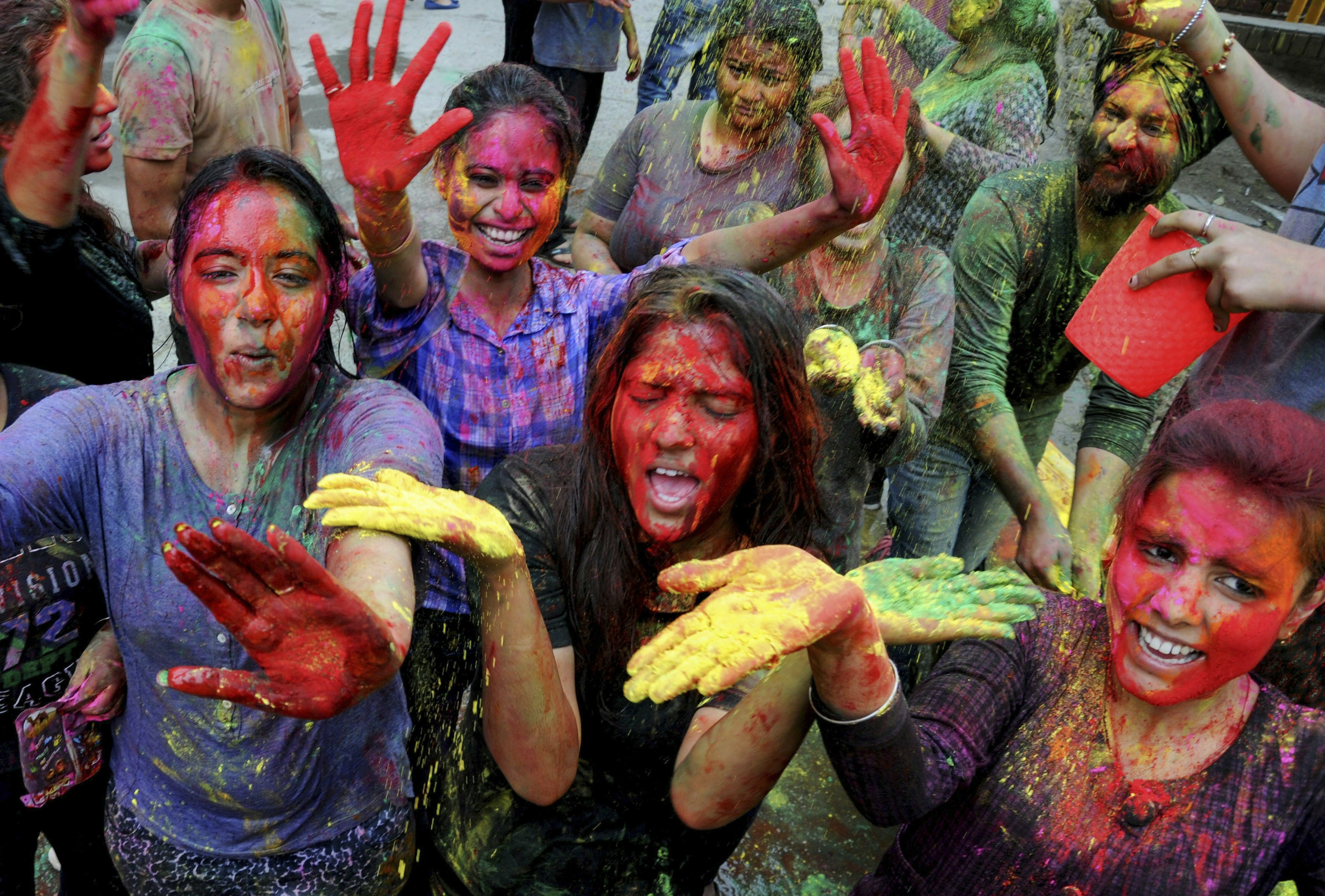 Students play with colours during 'Holi' celebrations, at Guru Nanak Dev University in Amritsar - PTI