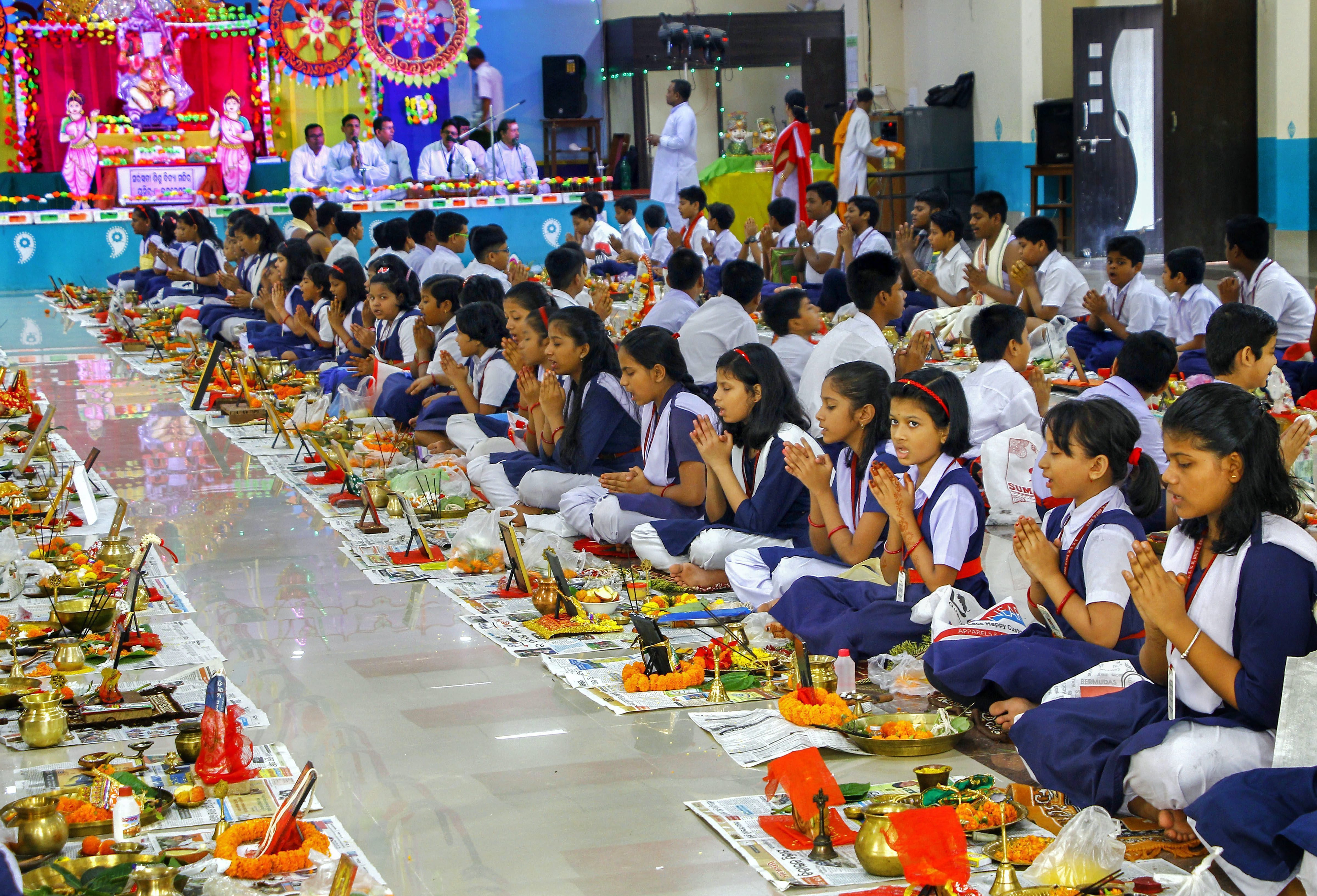 Students perform mass 'Puja' at Swaraswati Bidya Mandir on occasion of 'Ganesh Chaturthi' festival, in Bhubaneswar - PTI
