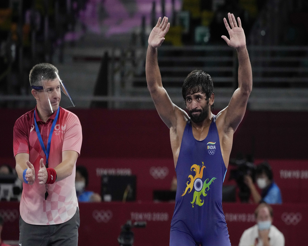 India's Bajrang Bajrang celebrates after defeating Kazakhstan's Daulet Niyazbekov during their men's freestyle 65kg wrestling bronze medal match at the 2020 Summer Olympics