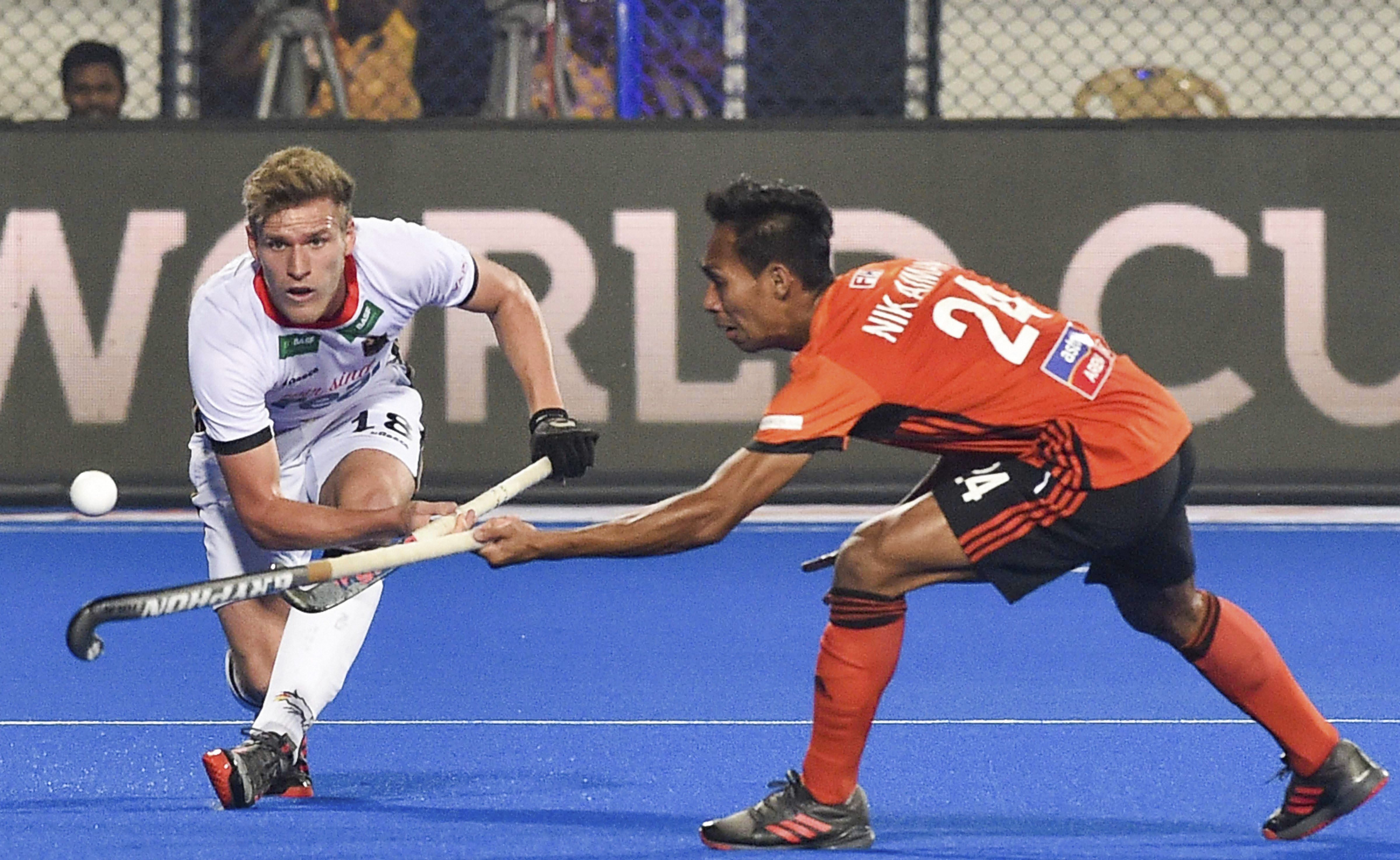Germany's Ferdinand Weinke (in white) and Malaysia's Aiman Rozemi vie for the ball during their match, at Men's Hockey World Cup 2018, in Bhubaneswar - PTI