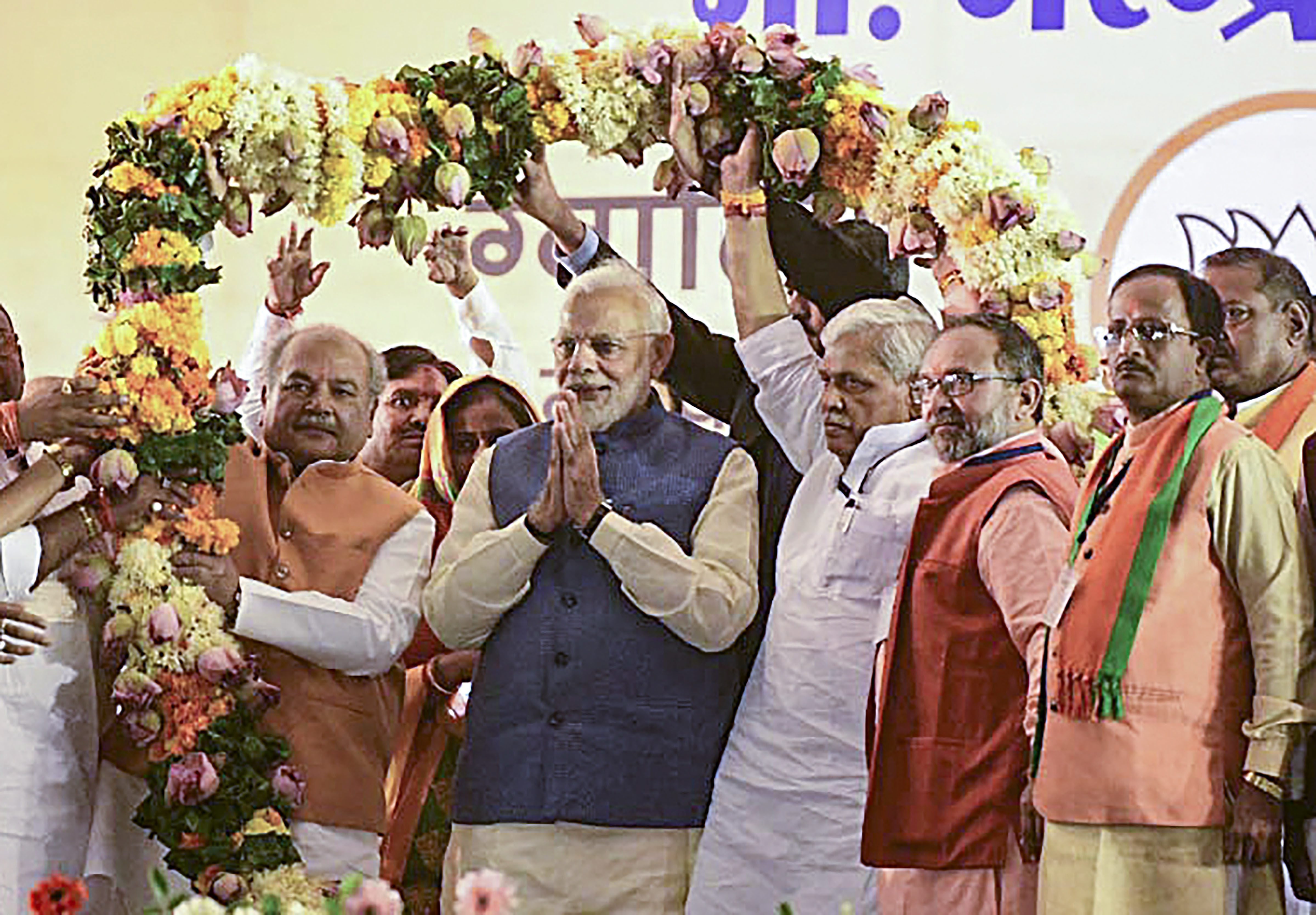Prime Minister Narendra Modi being garlanded at a public meeting ahead of Madhya Pradesh Assembly elections, in Gwalior - PTI