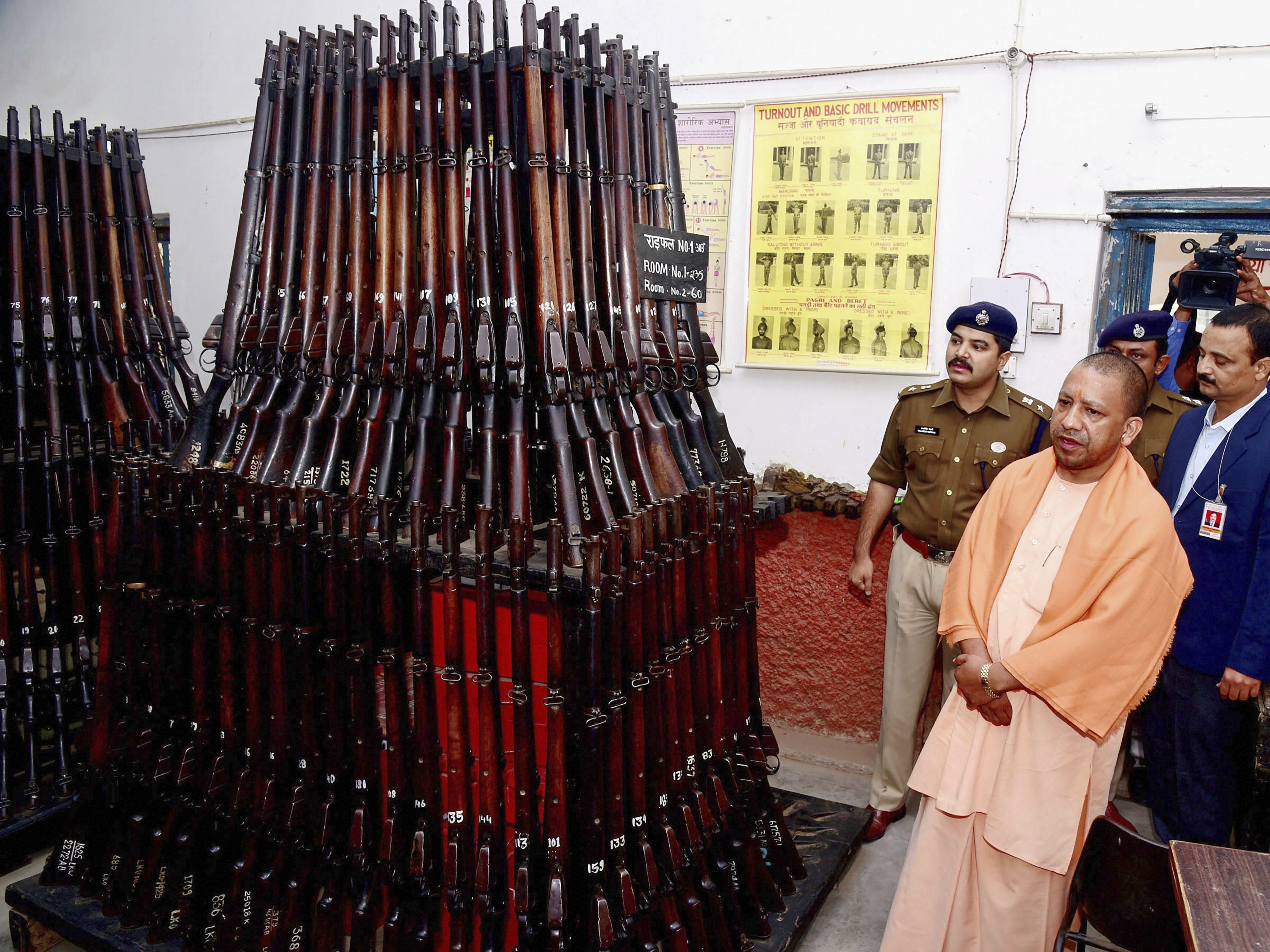 ttar Pradesh Chief Minister Yogi Adityanath inspects weapons during a surprise visit to Police Lines, in Lucknow - PTI