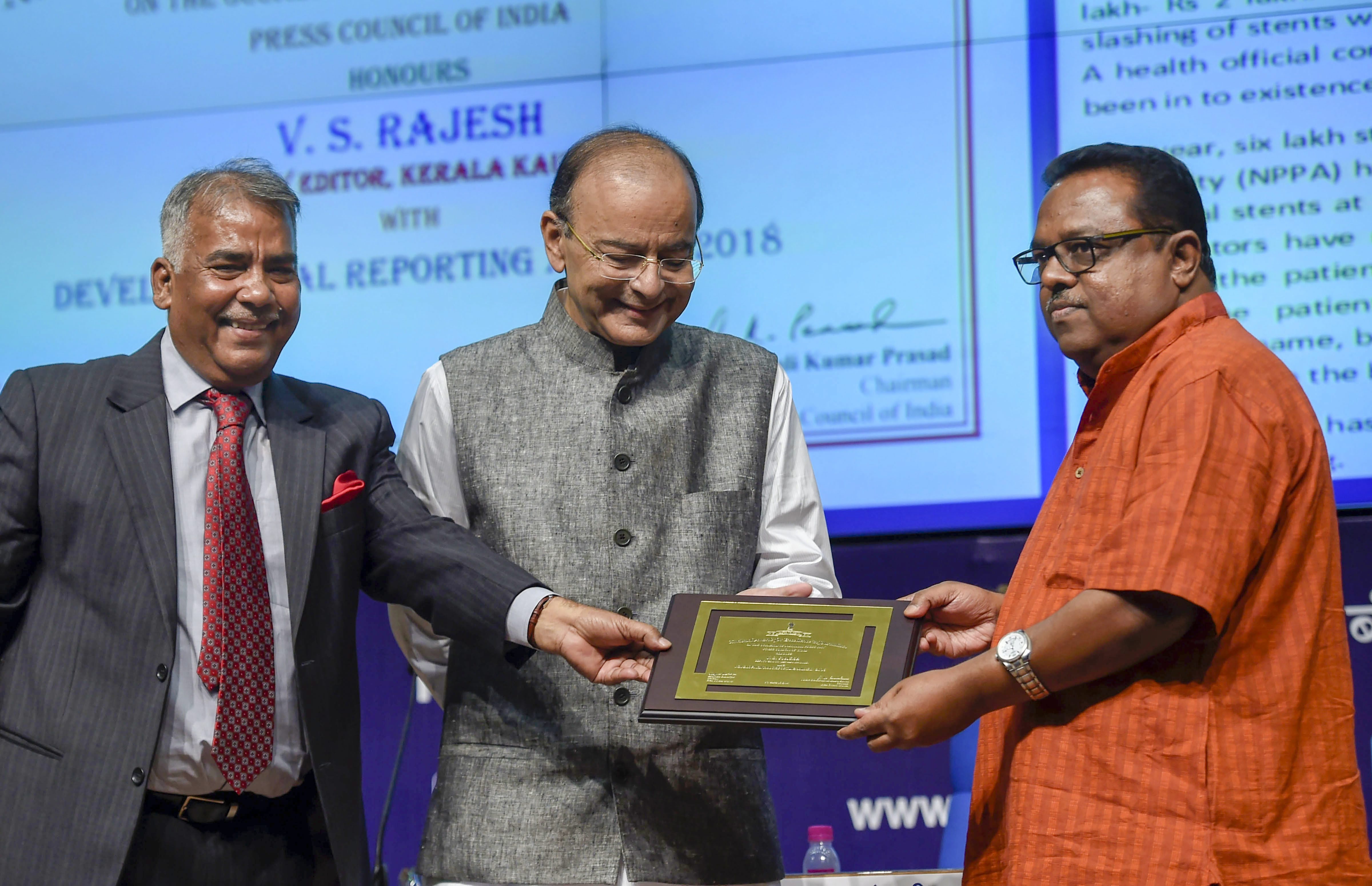 Finance Minister Arun Jaitley and Chairman Press Council of India, Justice Chandramauli Kumar Prasad, present the 'Development Reporting Award' to Deputy Editor Kerala Kaumudi, V S Rajesh, during the National Press Day celebrations and Conferring of National Awards for Excellence in Journalism-2018, in New Delhi - PTI