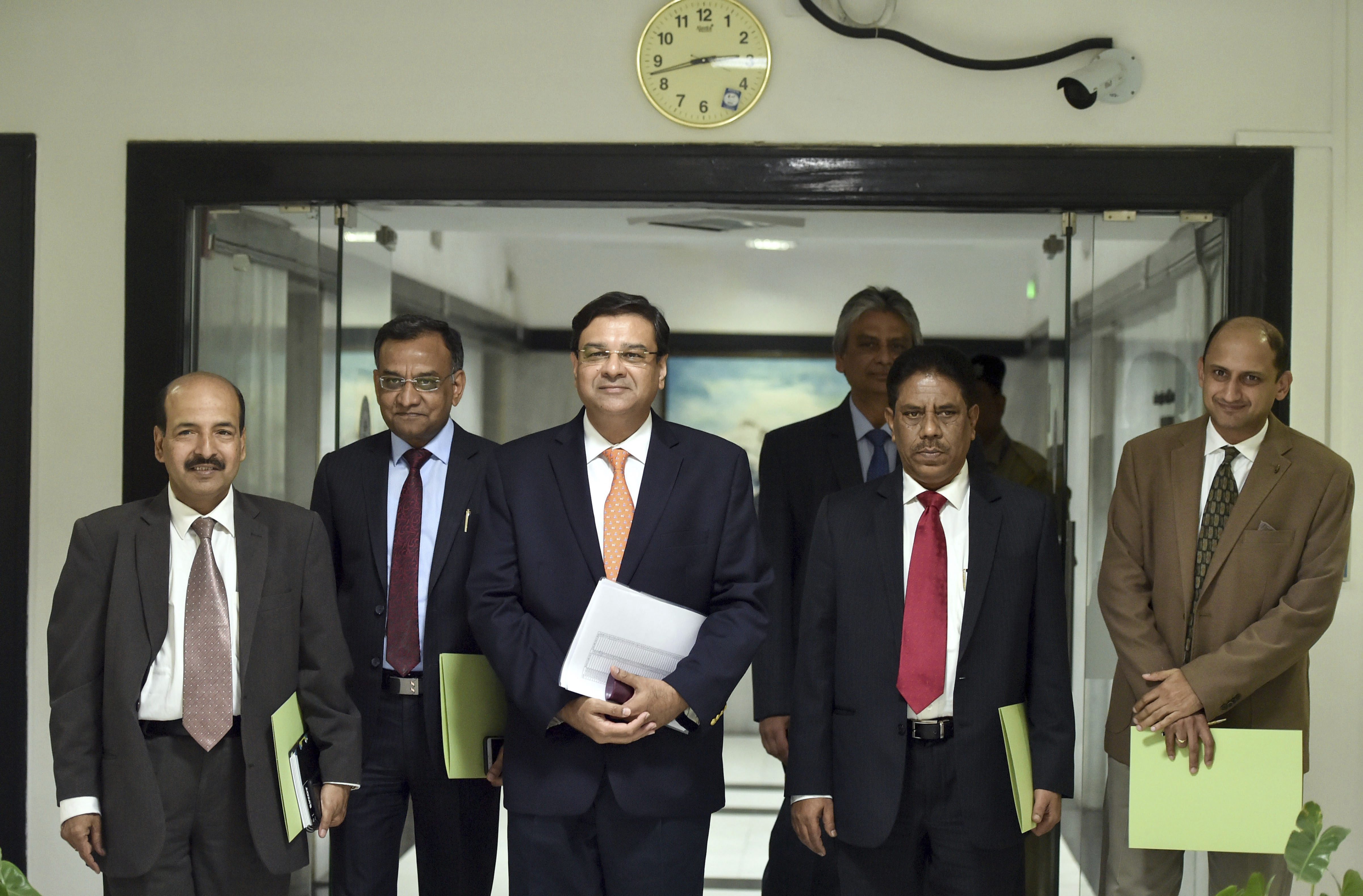 RBI Governor Urjit Patel (C) with deputy governors arrive for a post-monetary policy meeting press conference, at RBI Headquarters in Mumbai - PTI