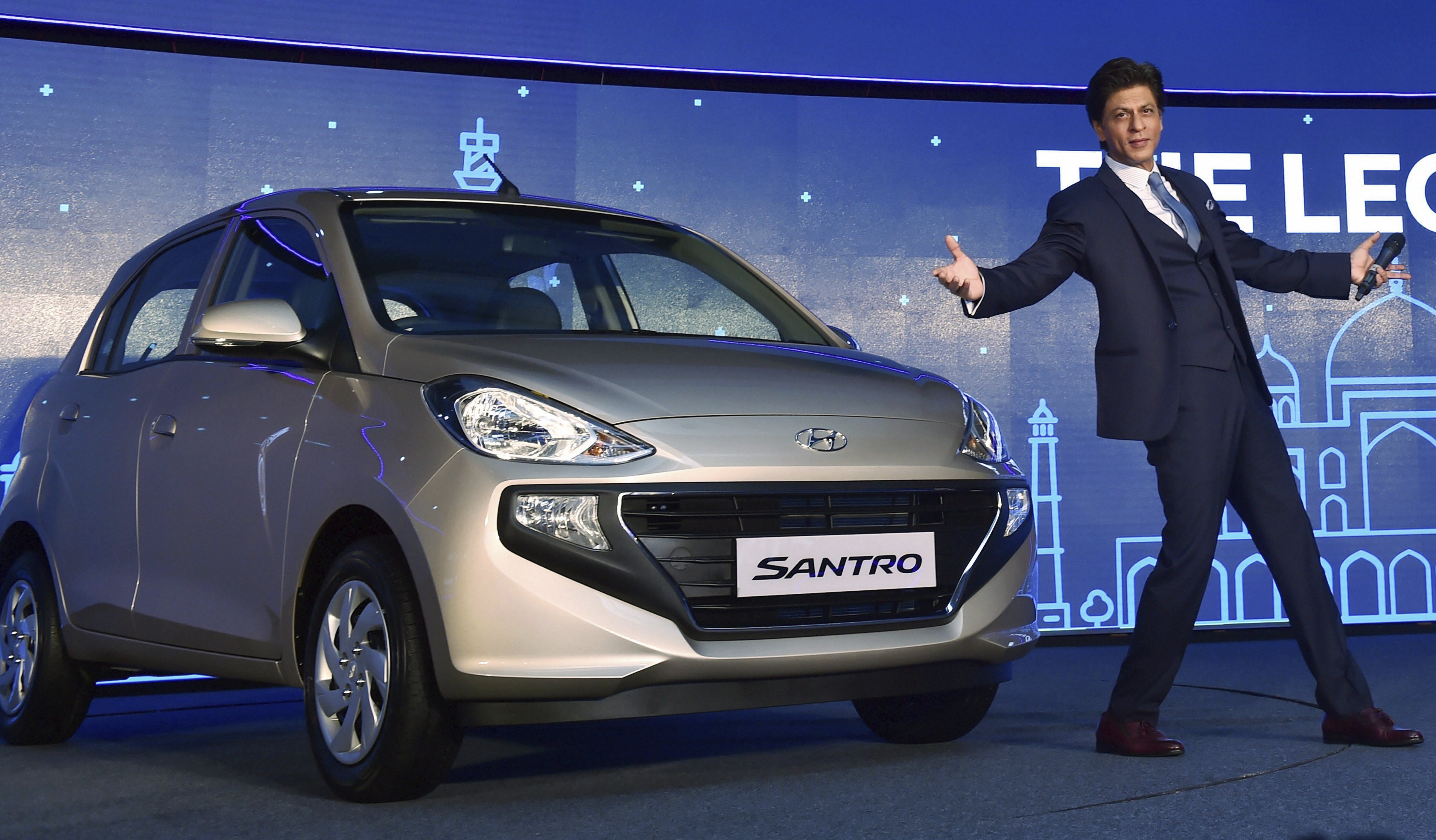 Bollywood actor & Hyundai brand ambassador Shah Rukh Khan poses for photos at the launch of the new Santro, in New Delhi - PTI