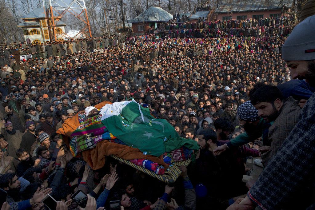 Kashmiri villagers carry the body of a local rebel Muzamil Ahmed Dar during his funeral procession in Rahmoo village south of Srinagar - AP