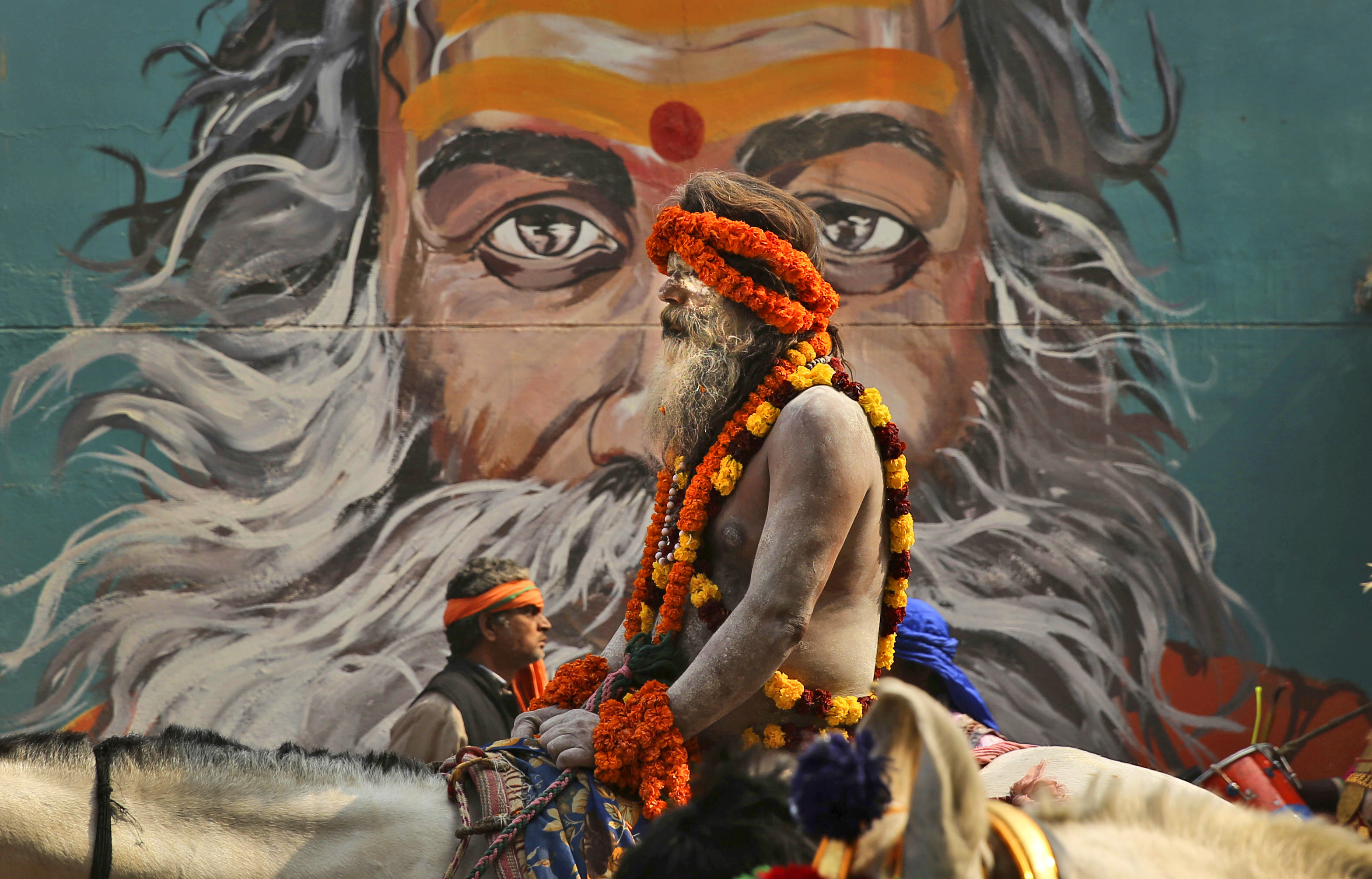 A horse mounted Naga Sadhu, or a naked Hindu holy man rides during a religious procession towards the Sangam, the confluence of rivers Ganges, Yamuna and mythical Saraswati, as part of the Kumbh festival in Allahabad - AP