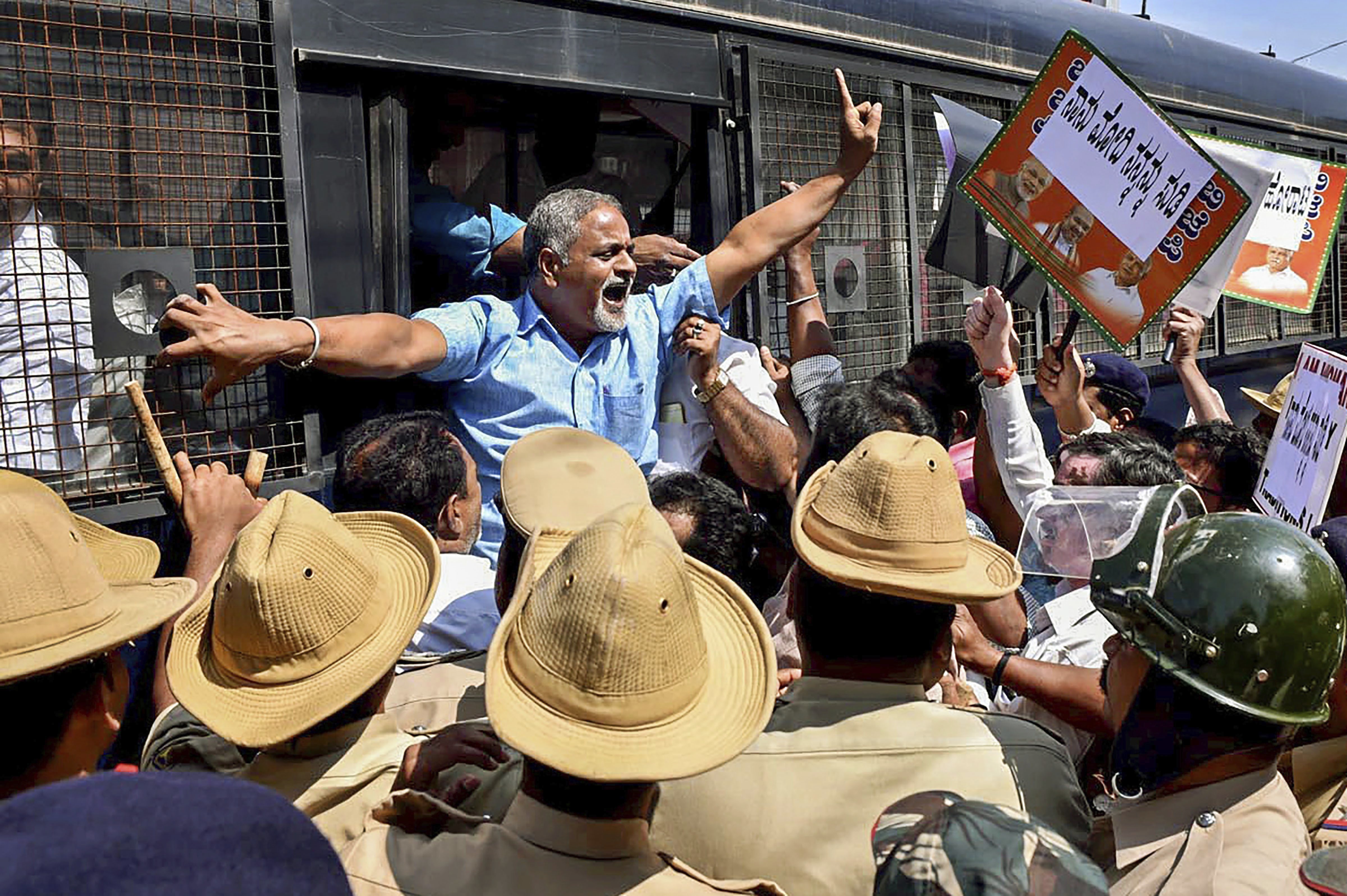 Police detain BJP activists who were protesting against Congress leader TB Jayachandra for his remarks over Prime Minister Narendra Modi, in Chikmagalur, Karnataka - PTI