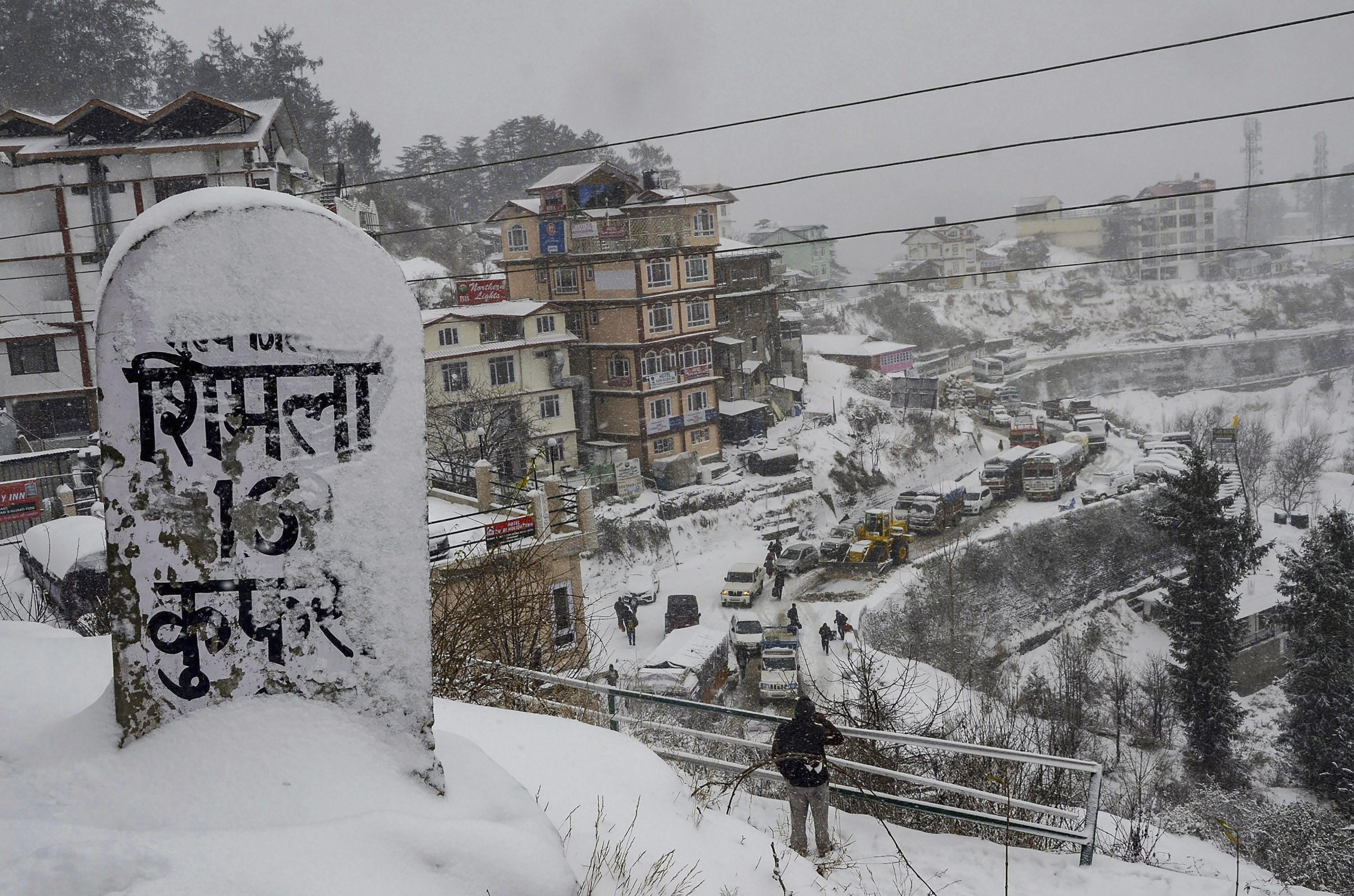 A milestone covered in snow following heavy snowfall, at Kufri near Shimla - PTI