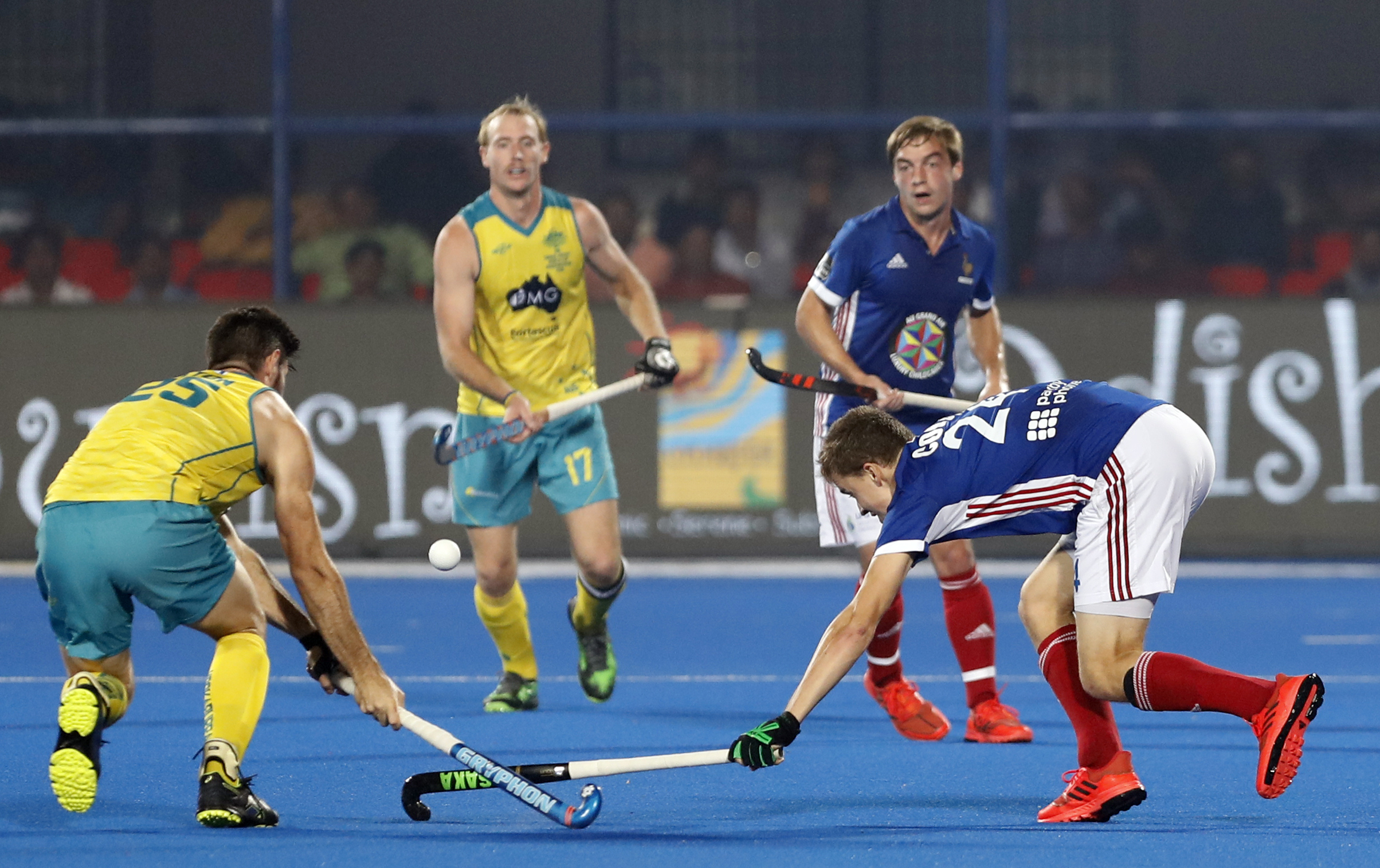 French and Australian players compete for the ball during the Men's Hockey World Cup quarterfinal match between France and Australia at the Kalinga Stadium in Bhubaneswar - AP