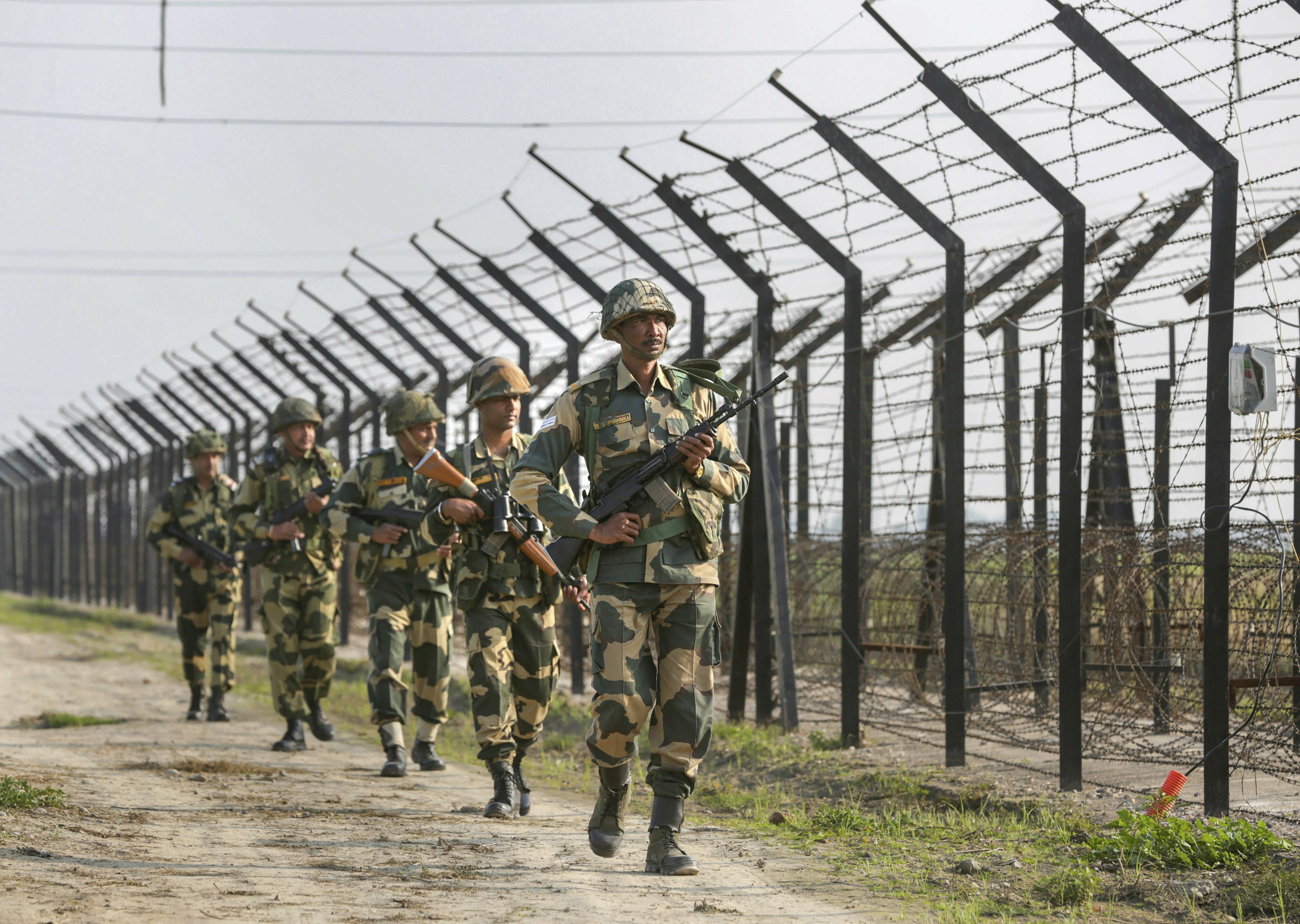 Border Security Force (BSF) personnel patrol along the international border as security beefs up amid escalating tension between India and Pakistan, at Attari near Amritsar - PTI