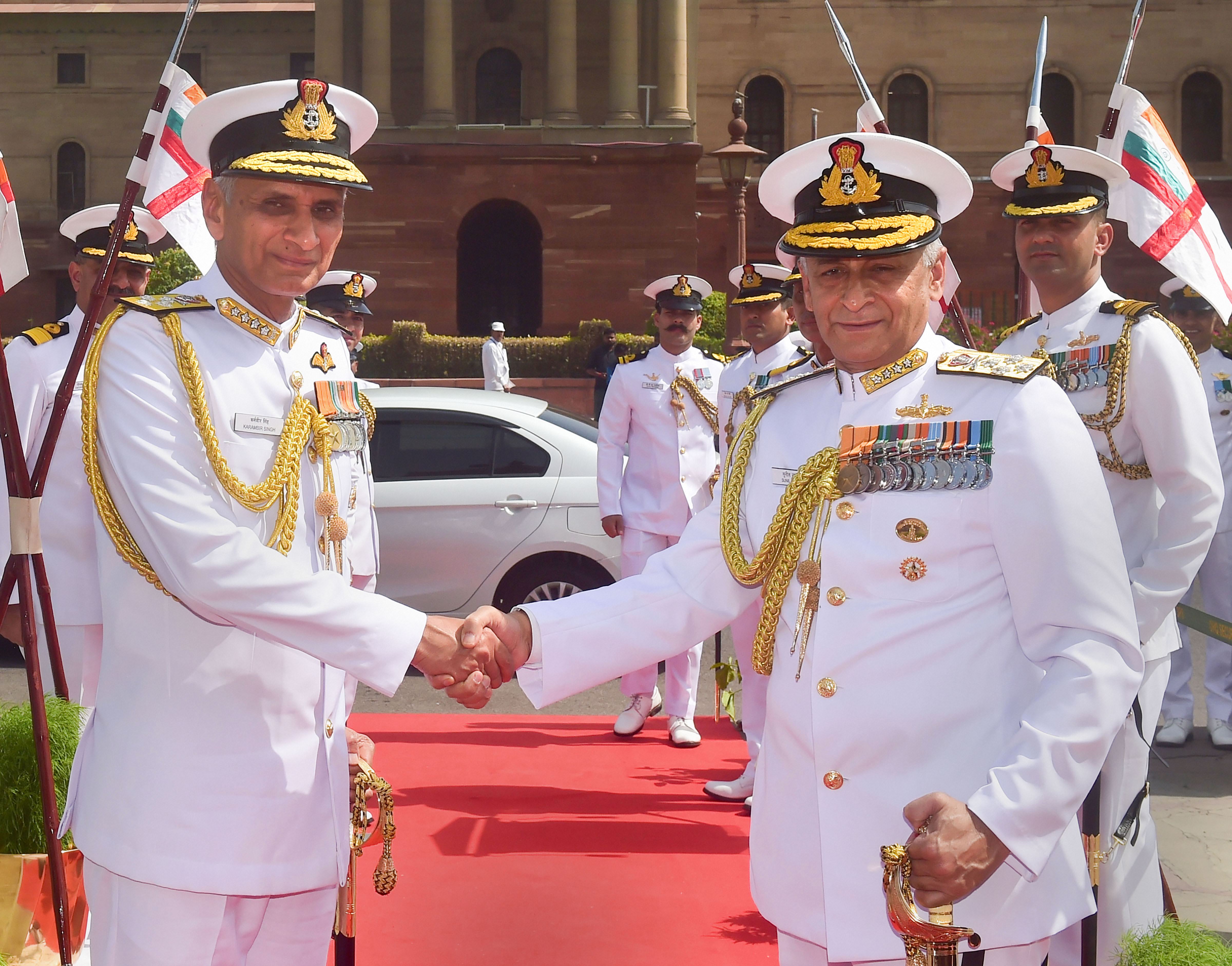 Admiral Karambir Singh shakes hands with outgoing Navy Chief Admiral Sunil Lanba during the Guard of Honour, before taking charge as the 24th Chief of the Naval Staff, at South Block in New Delhi - PTI