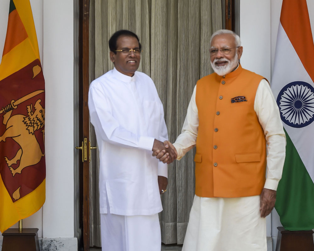 Prime Minister Narendra Modi shakes hands with Sri Lankan President Maithripala Sirisena prior to their bilateral meeting at Hyderabad House in New Delhi - PTI