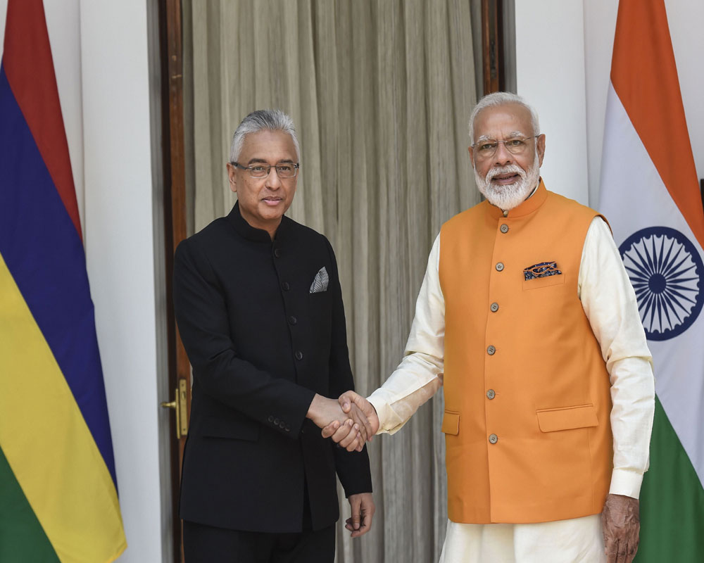 Prime Minister Narendra Modi shakes hands with Mauritius Prime Minister Pravind Kumar Jugnauth prior to their bilateral meeting at Hyderabad House, in New Delhi - PTI