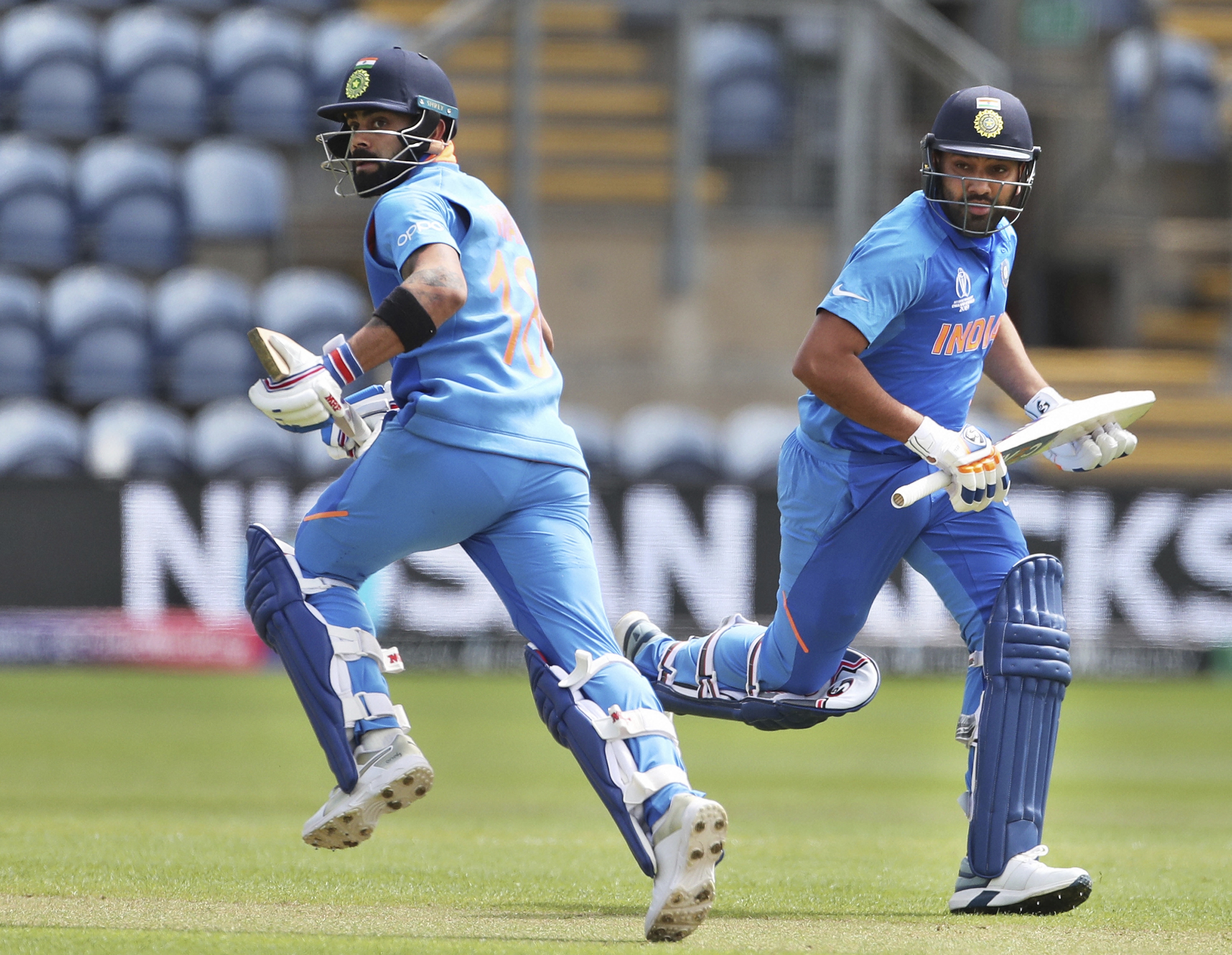 India's captain Virat Kohli, left, and Rohit Sharma run between the wickets to score during the Cricket World Cup warm up match between Bangladesh and India at Sophia Gardens in Cardiff - PTI