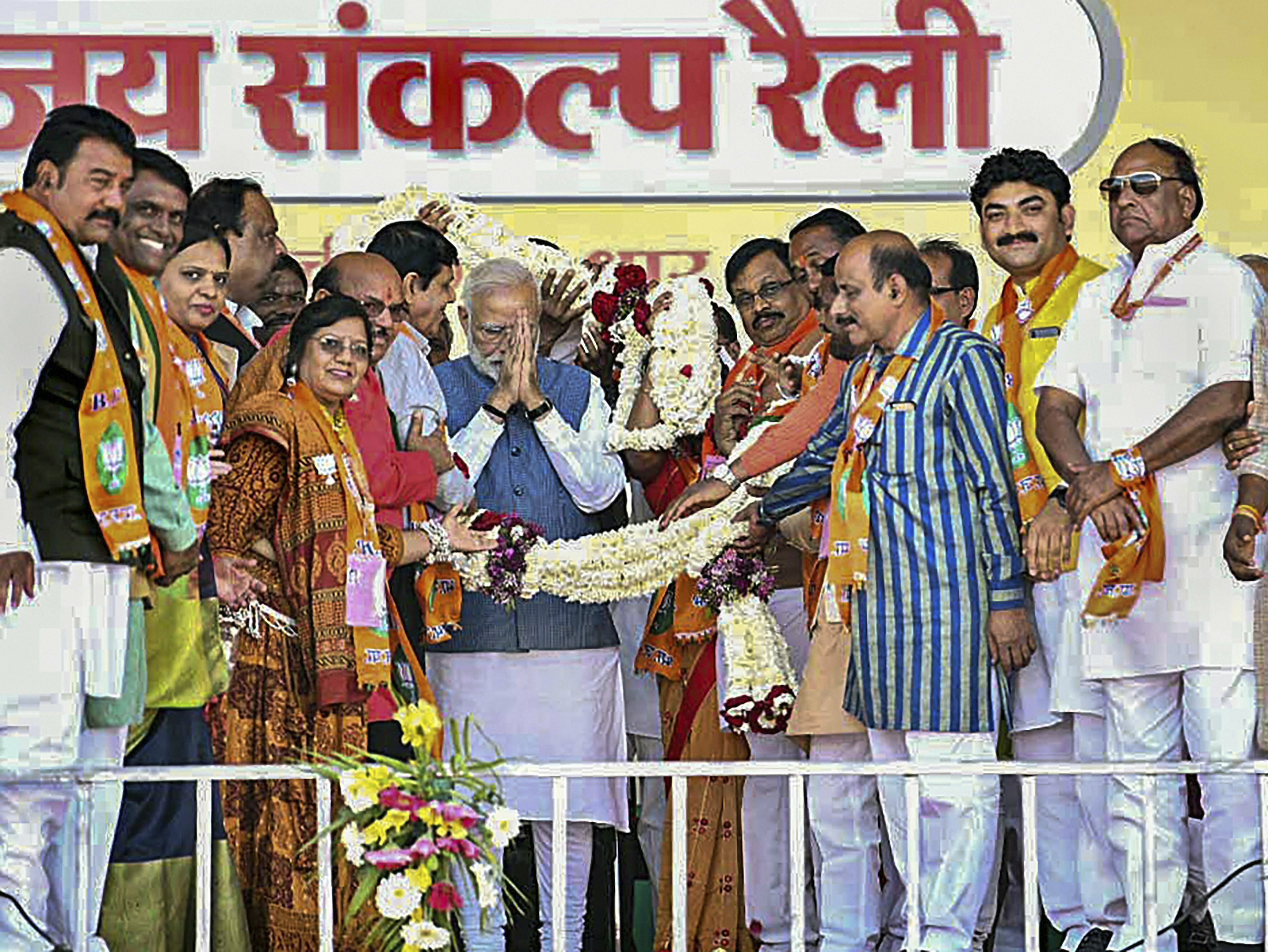 Prime Minister Narendra Modi is greeted by his party workers during Vijay Sankalp rally, in Dhar - PTI