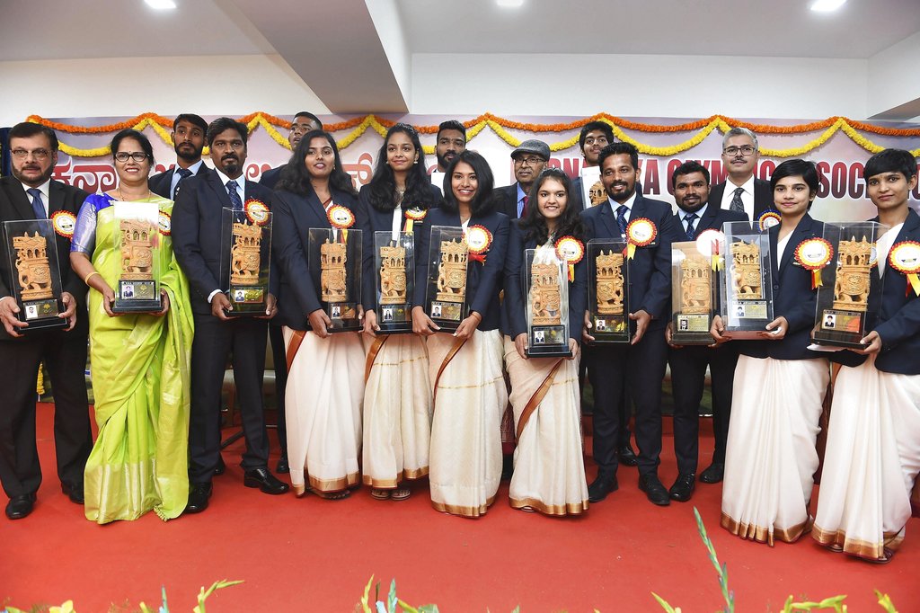 Sports persons hold their awards during the annual award ceremony of Karnataka Olympic Association, in Bengaluru - AP