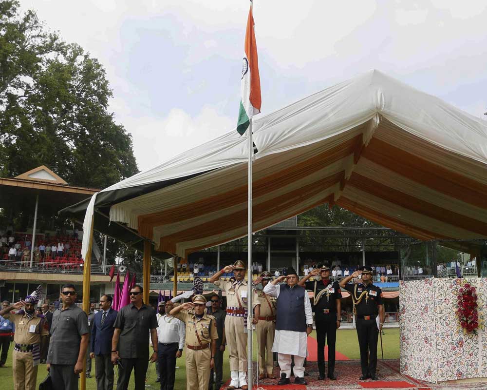 Jammu and Kashmir state Governor Satyapal Malik, in white and black dress salutes as he hoists an Indian flag to mark India's Independence Day in Srinagar, India, Thursday, Aug. 15, 2019.  Indian Prime Minister Narendra Modi defended his government's controversial measure to strip the disputed Kashmir region of its statehood and special constitutional provisions in an Independence Day speech Thursday, as about 7 million Kashmiris stayed indoors for the 11th day of an unprecedented security lockdown and communications blackout - PTI
