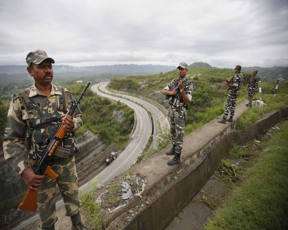 CRPF personnel stand guard on Jammu-Srinagar national highway on the eve of  73rd Independence Day celebrations, in Jammu - PTI