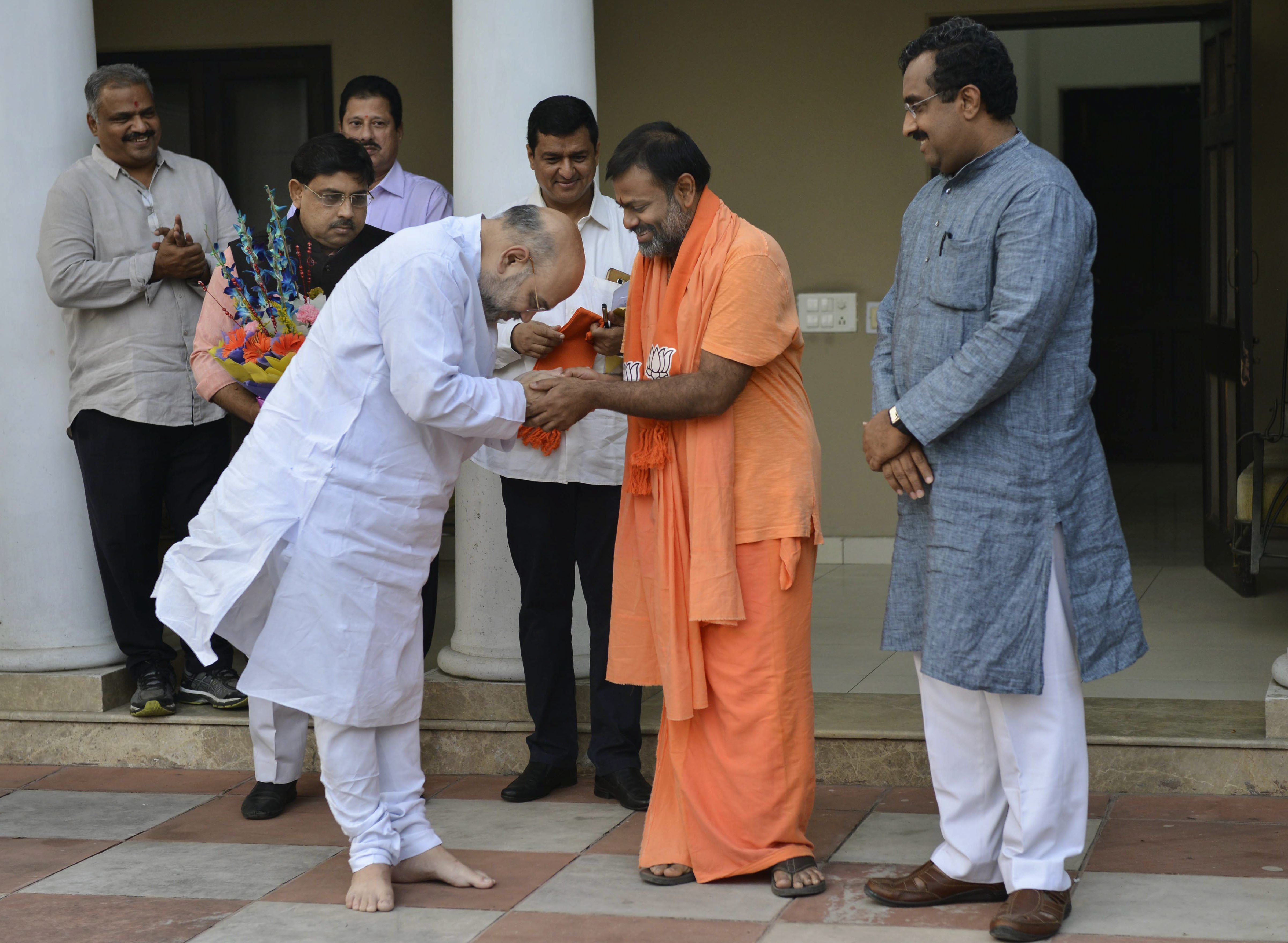Swami Paripurnanand from Telangana joins Bharatiya Janata Party in presence of the party chief Amit Shah and Ram Madhav, in New Delhi - PTI