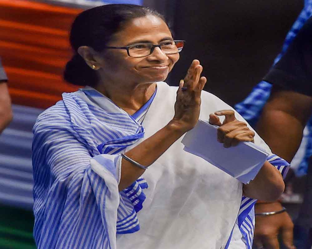 est Bengal Chief Minister Mamata Banerjee waves at her supporter during an organisational meeting of West Bengal State Employees Federation at Netaji Indoor Stadium, in Kolkata - PTI