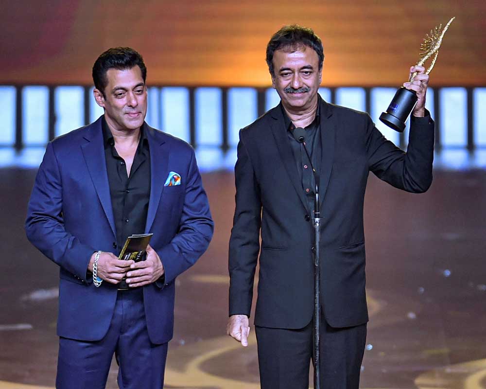 Bollywood actor Salman Khan presents an award for outstanding performance by a director in last 20 years to Rajkumar Hirani at the 20th IIFA awards ceremony in Mumbai - PTI