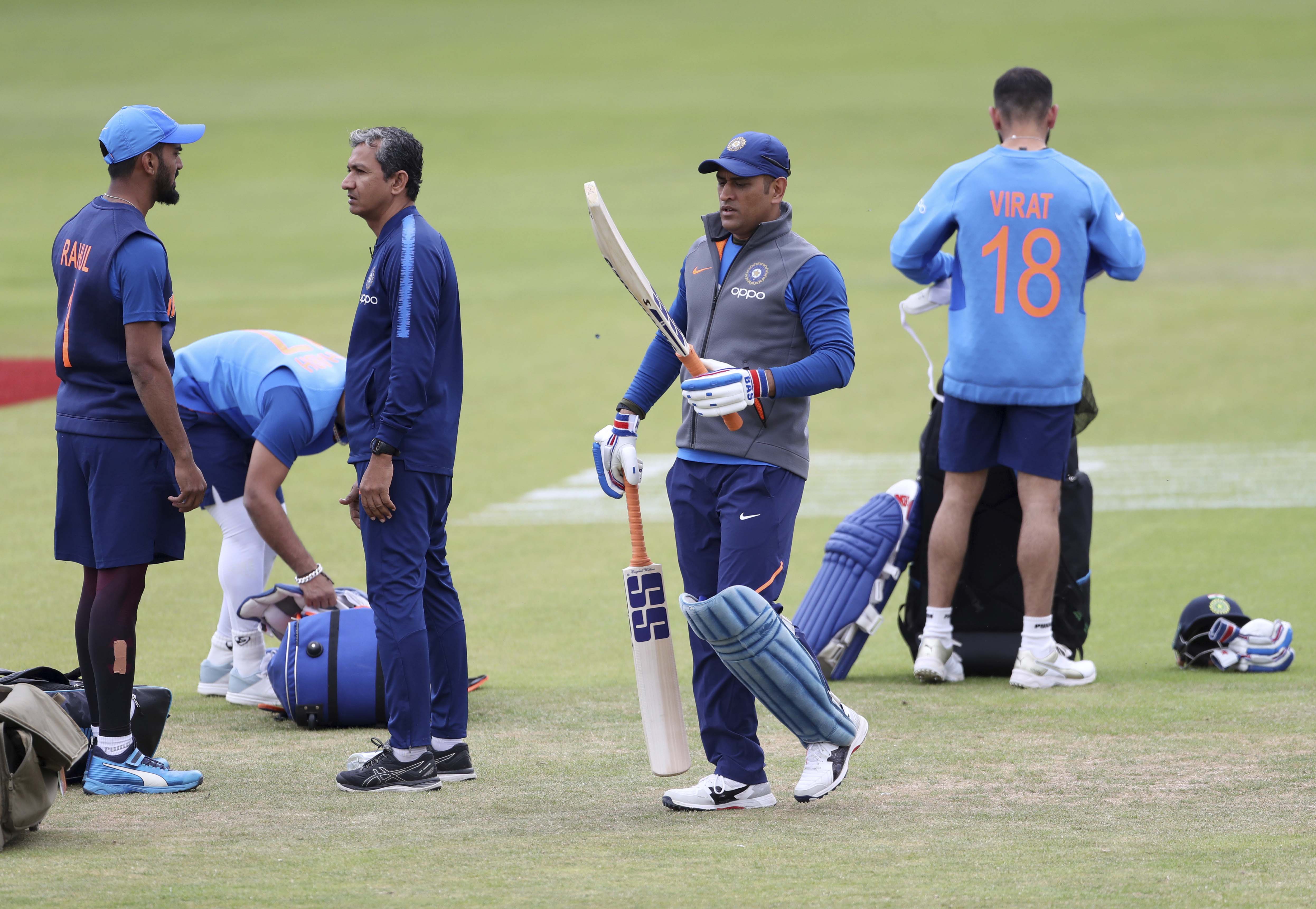 India's MS Dhoni, second right, carries his bats before batting in the nets during a training session ahead of their Cricket World Cup match against Sri Lanka at Headingley in Leeds, England - PTI