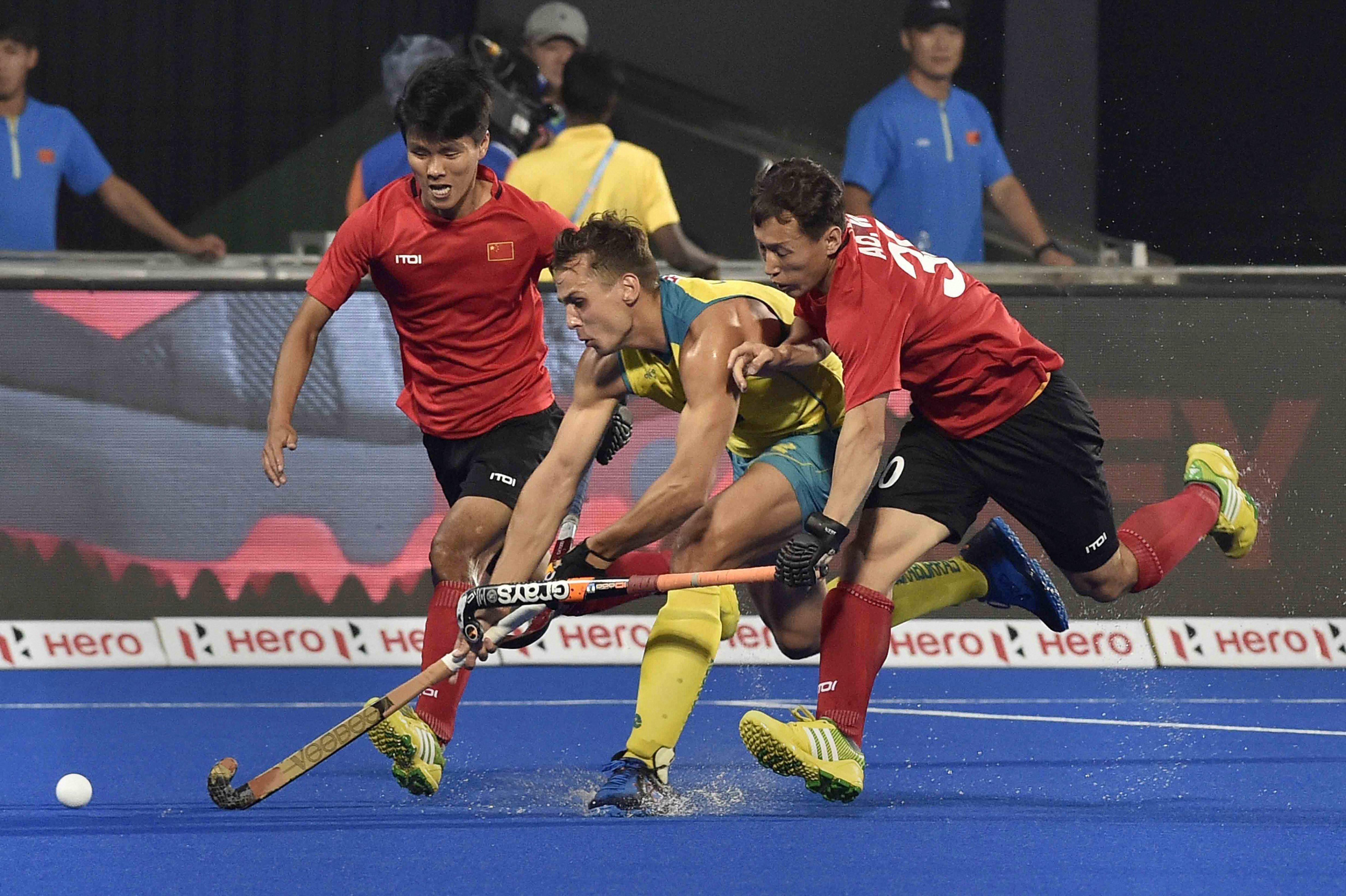 Australia's Tom Craig (in yellow) and Chinese players vie for the ball during their match at Men's Hockey World Cup 2018, in Bhubaneswar  - PTI